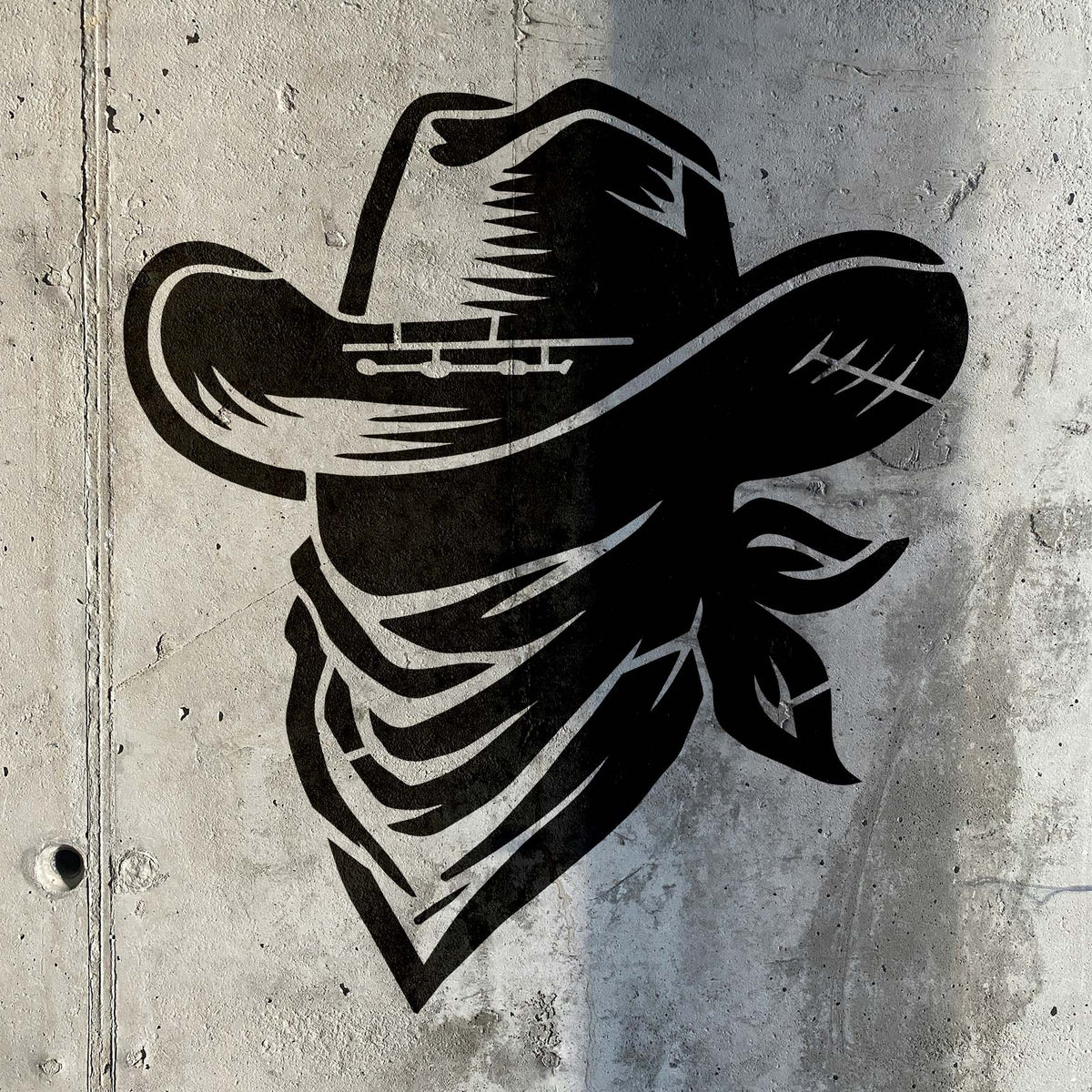Western charm meets raw concrete with the Cowboy Hat & Bandana Stencil in striking black detail.