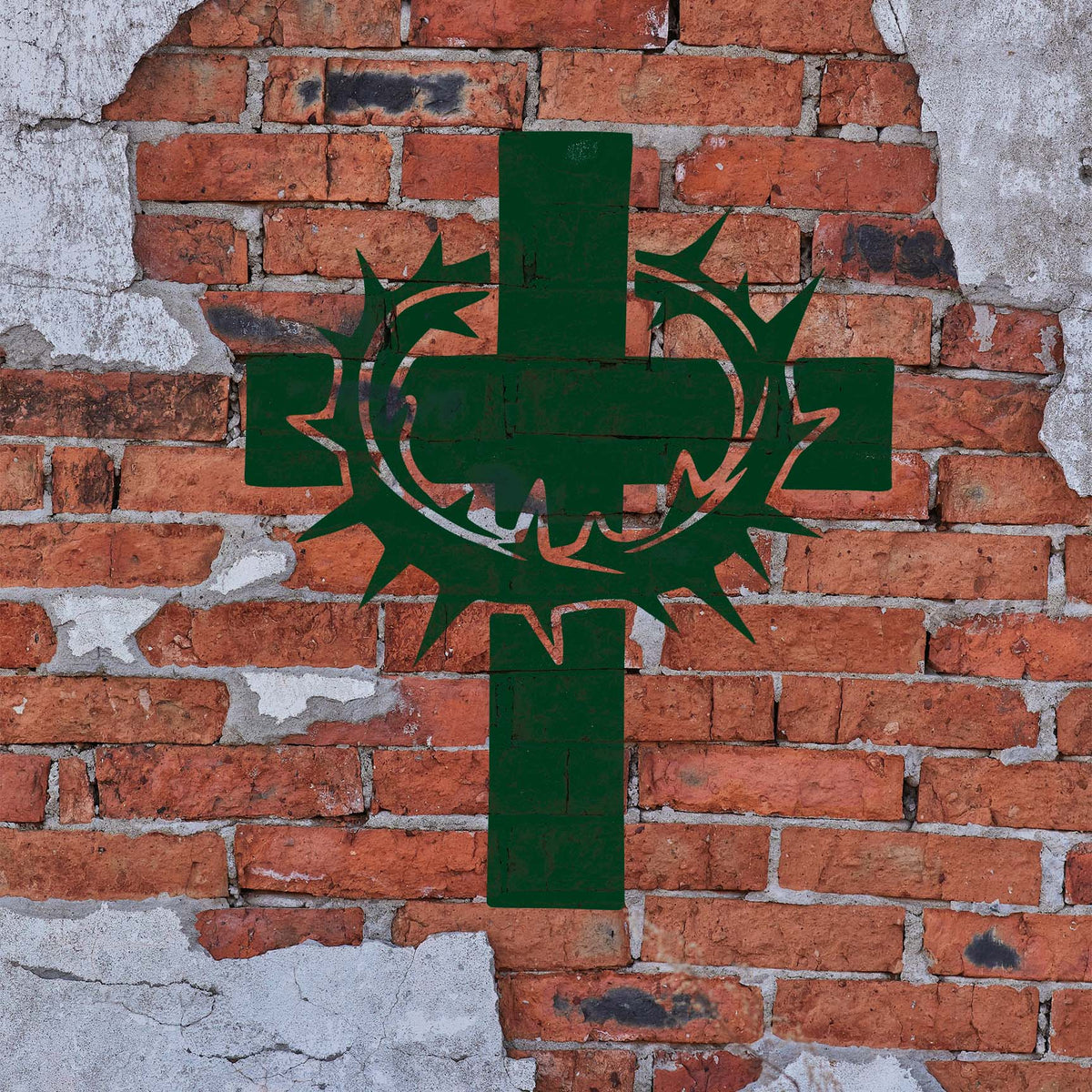 Cross with Crown of Thorns Stencil painted in green on a weathered red brick wall.