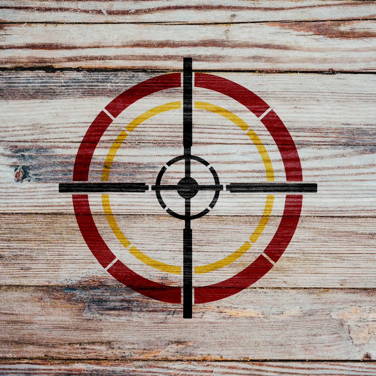 Rustic wood displays the Tactical Crosshair Reticle Stencil with red and yellow circular markings