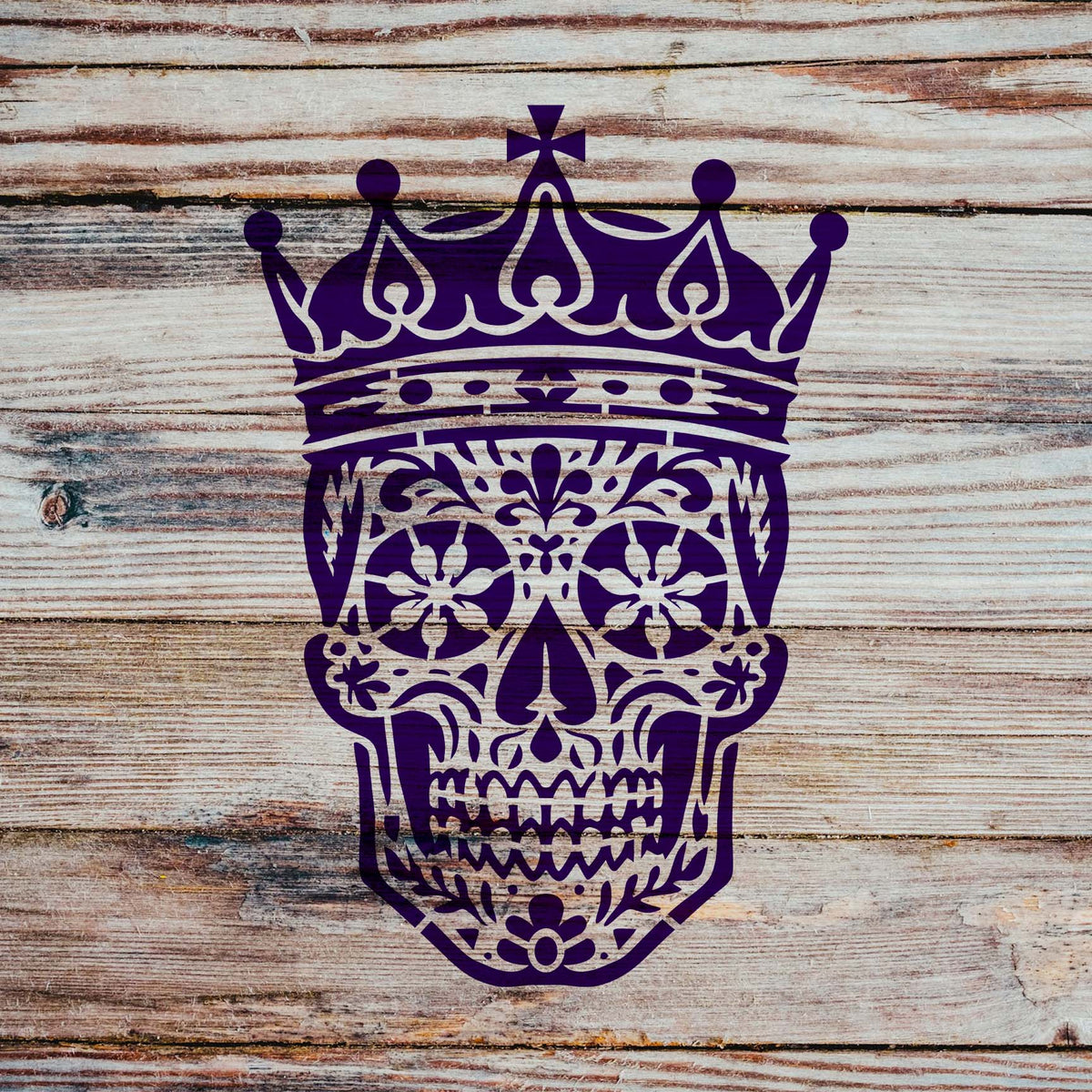 Rustic wood planks showcase the Crowned Sugar Skull Stencil with intricate purple floral details.