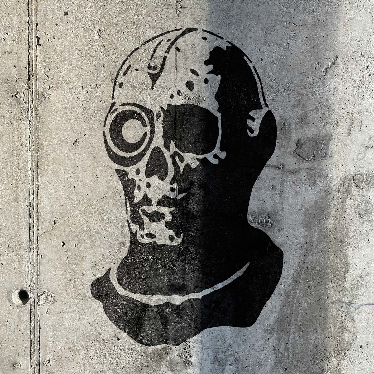Industrial concrete showcases the Cyborg Skull Stencil with bold mechanical skull details.