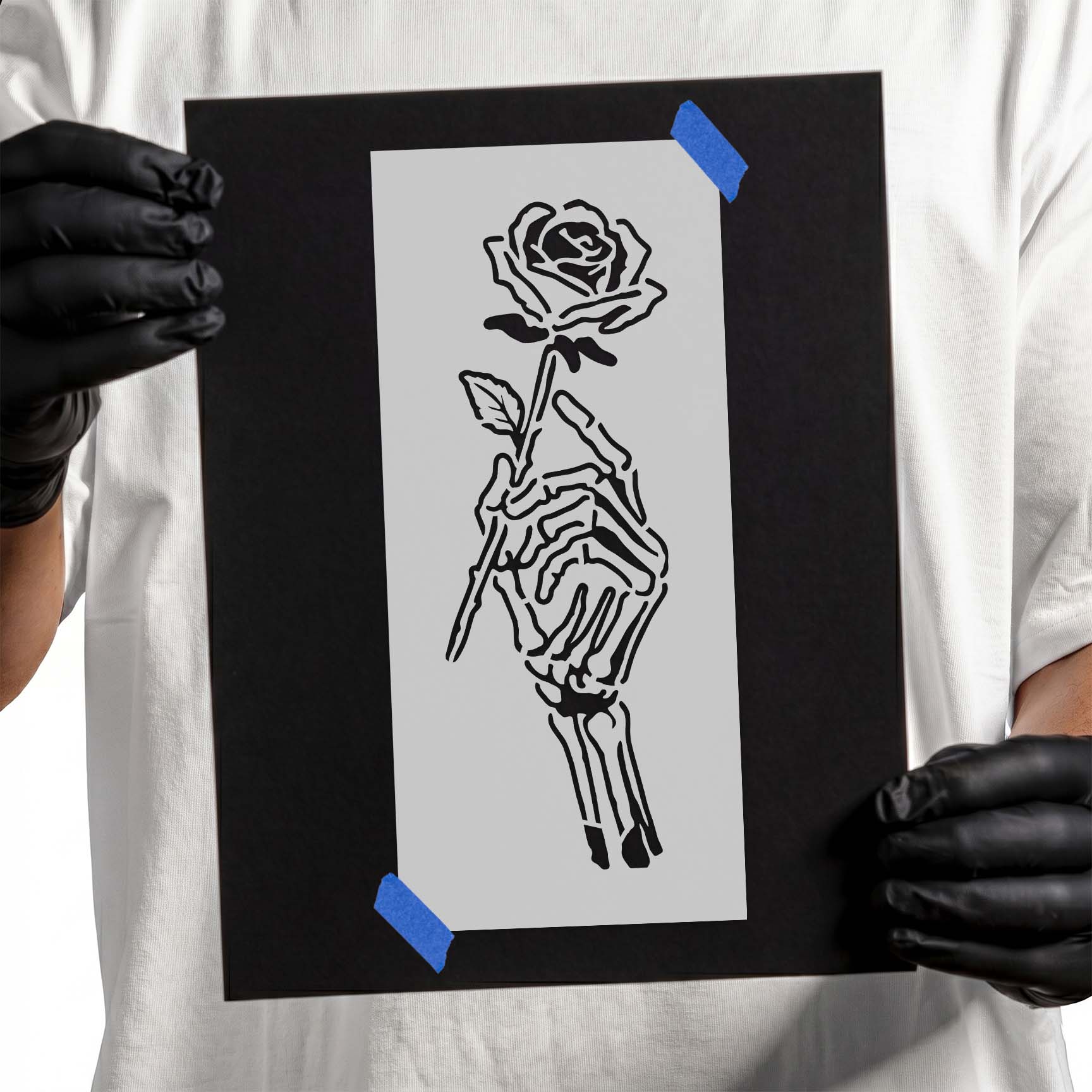 Detailed skeleton hand delicately holding a blooming rose in gothic style