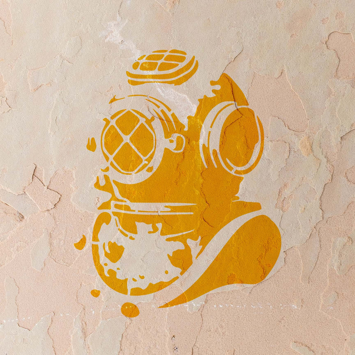Weathered stucco features the Deep Sea Diver Helmet Stencil in a bold golden finish