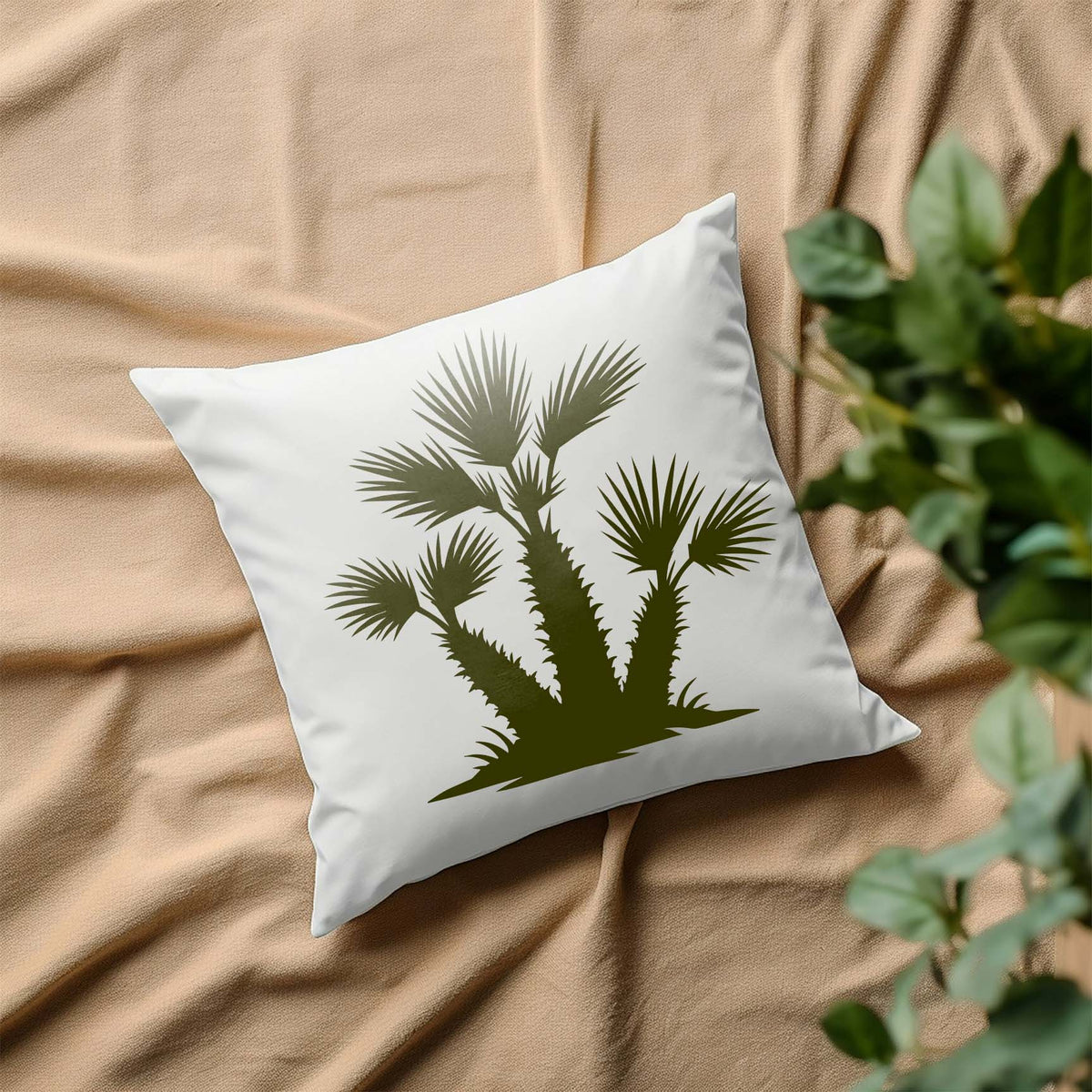 Olive Desert Fan Palm Cluster Stencil accents a white pillow with bold tropical silhouettes