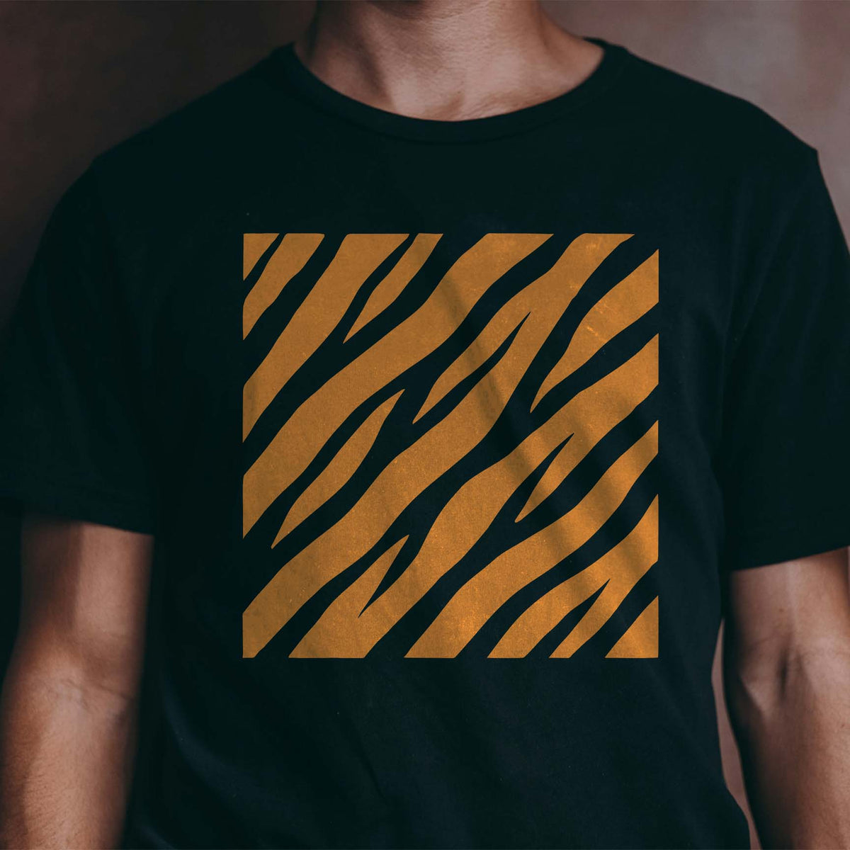 Diagonal Tiger Stripe Pattern Stencil creates bold orange stripes across a black T-shirt