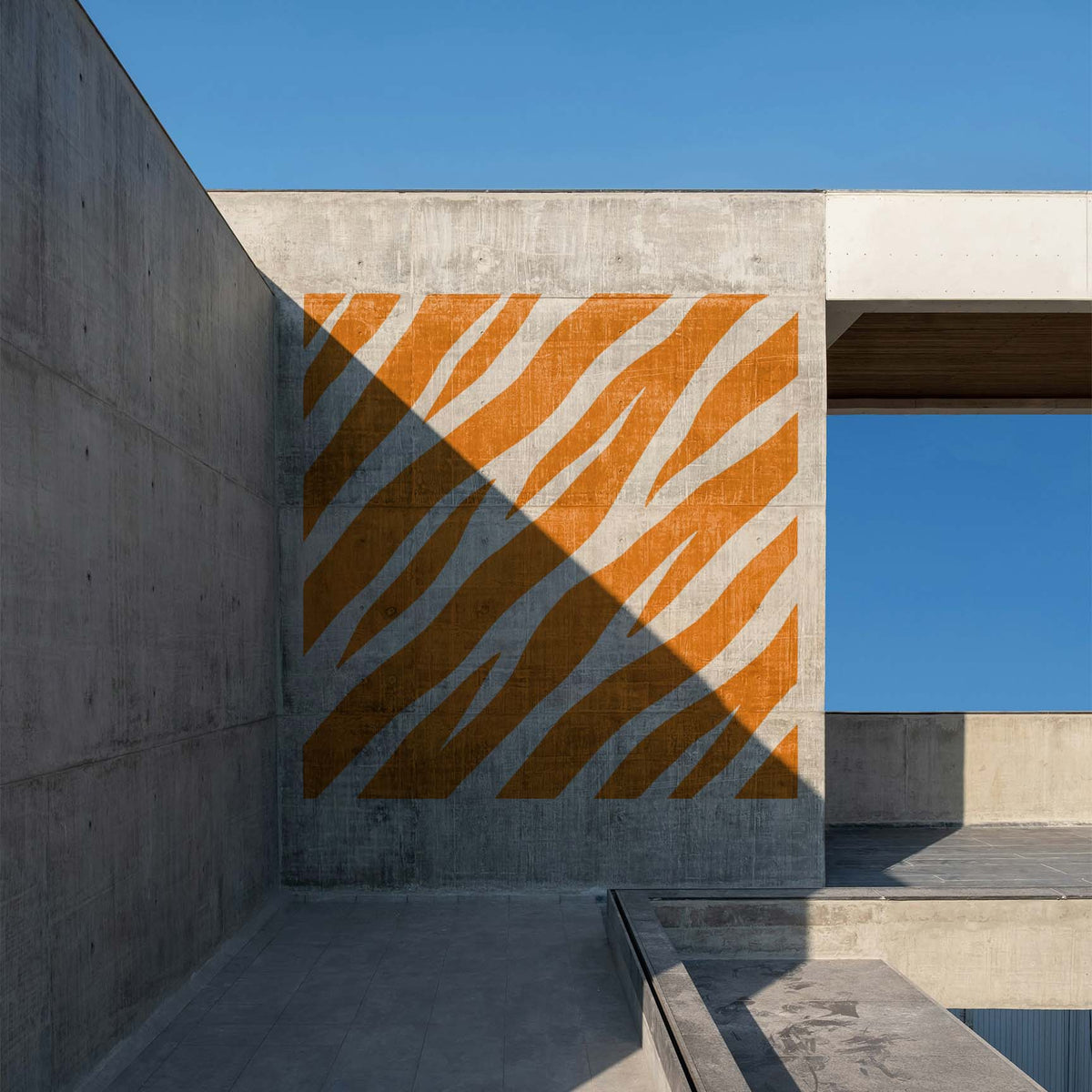 Orange Diagonal Tiger Stripe Pattern Stencil makes a striking mural on a concrete wall