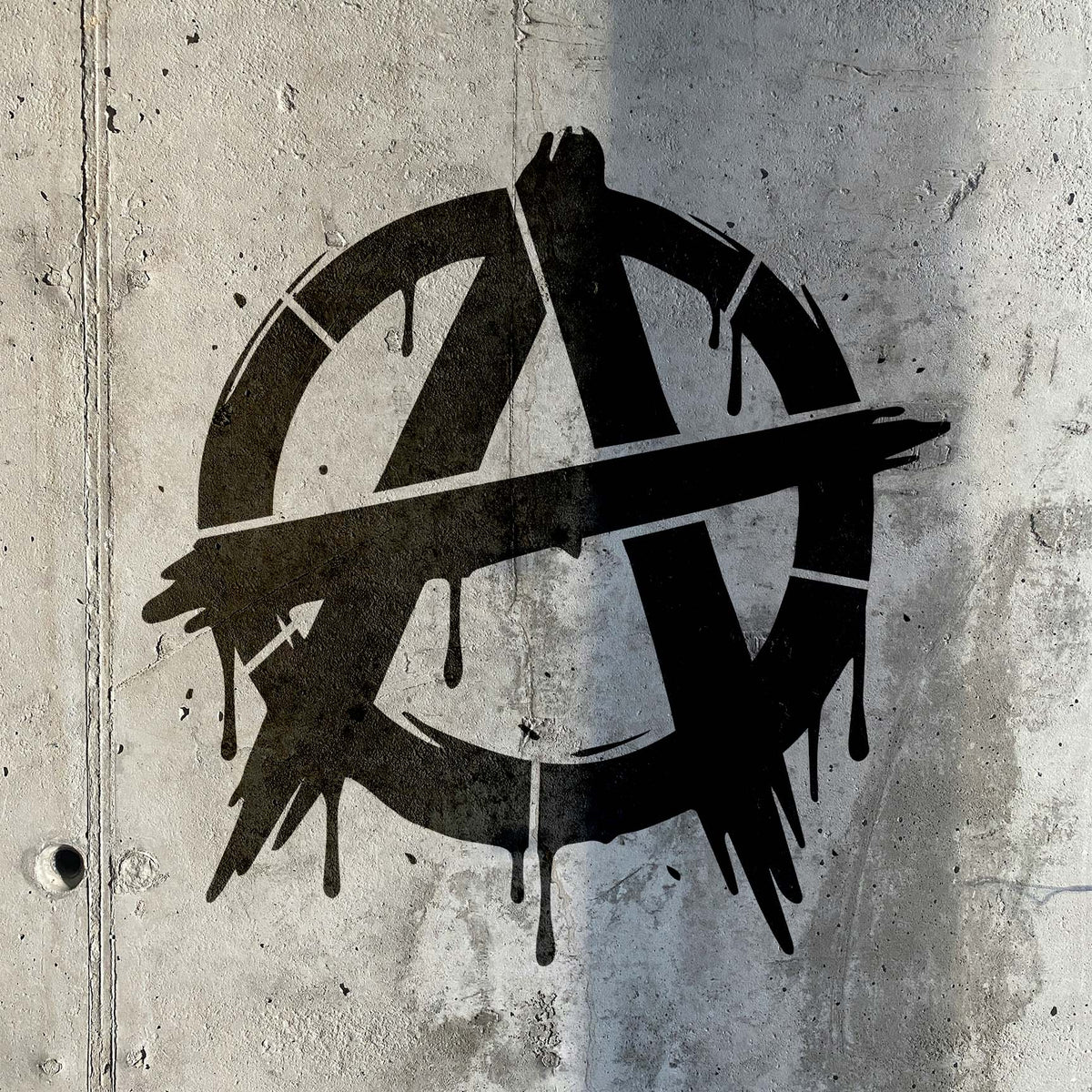 Bold black paint drips define the Distressed Anarchy Symbol Graffiti Stencil on a textured concrete wall.