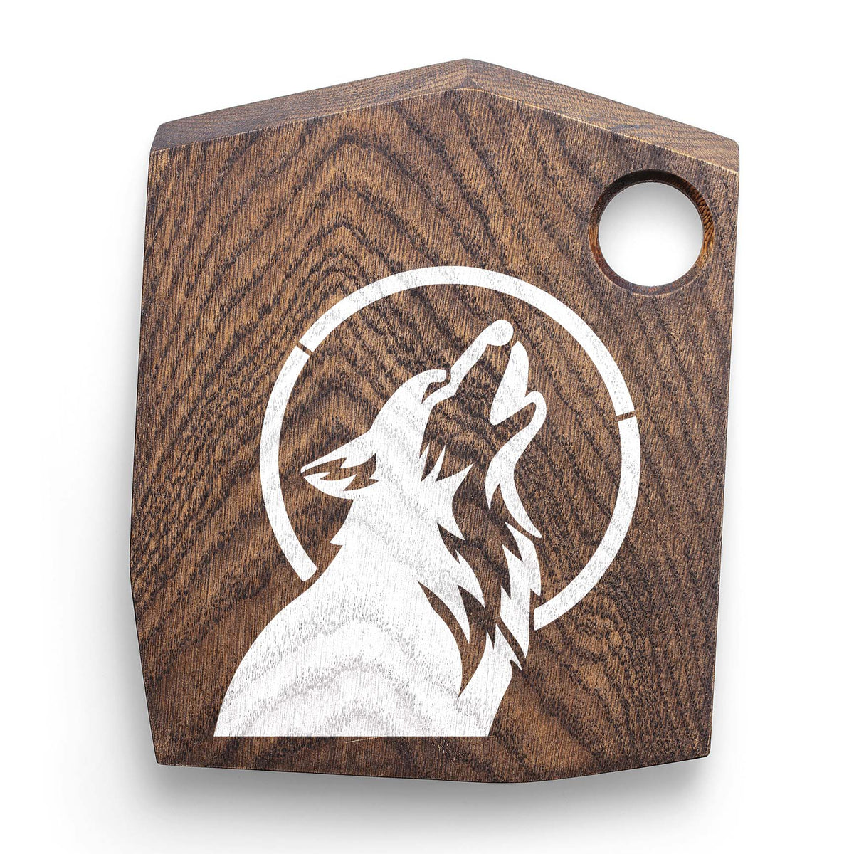 Dog Howling at Moon Stencil featured in white on a dark wood cutting board.