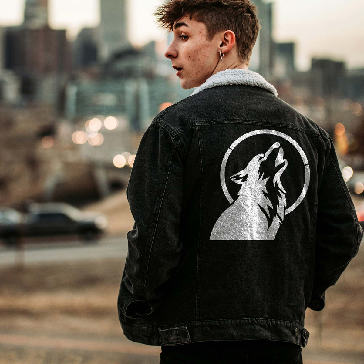 Dog Howling at Moon Stencil printed in white on the back of a black denim jacket.