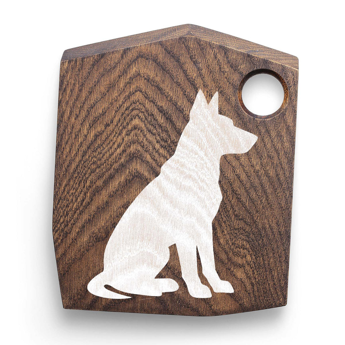 White Sitting Dog Silhouette Stencil stands out against a richly grained wooden cutting board