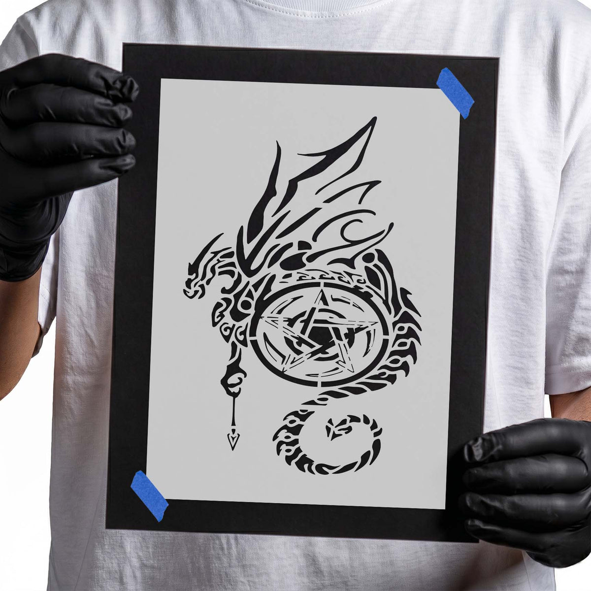 Tribal dragon stencil with sweeping wings curled tail and circular pentagram symbol