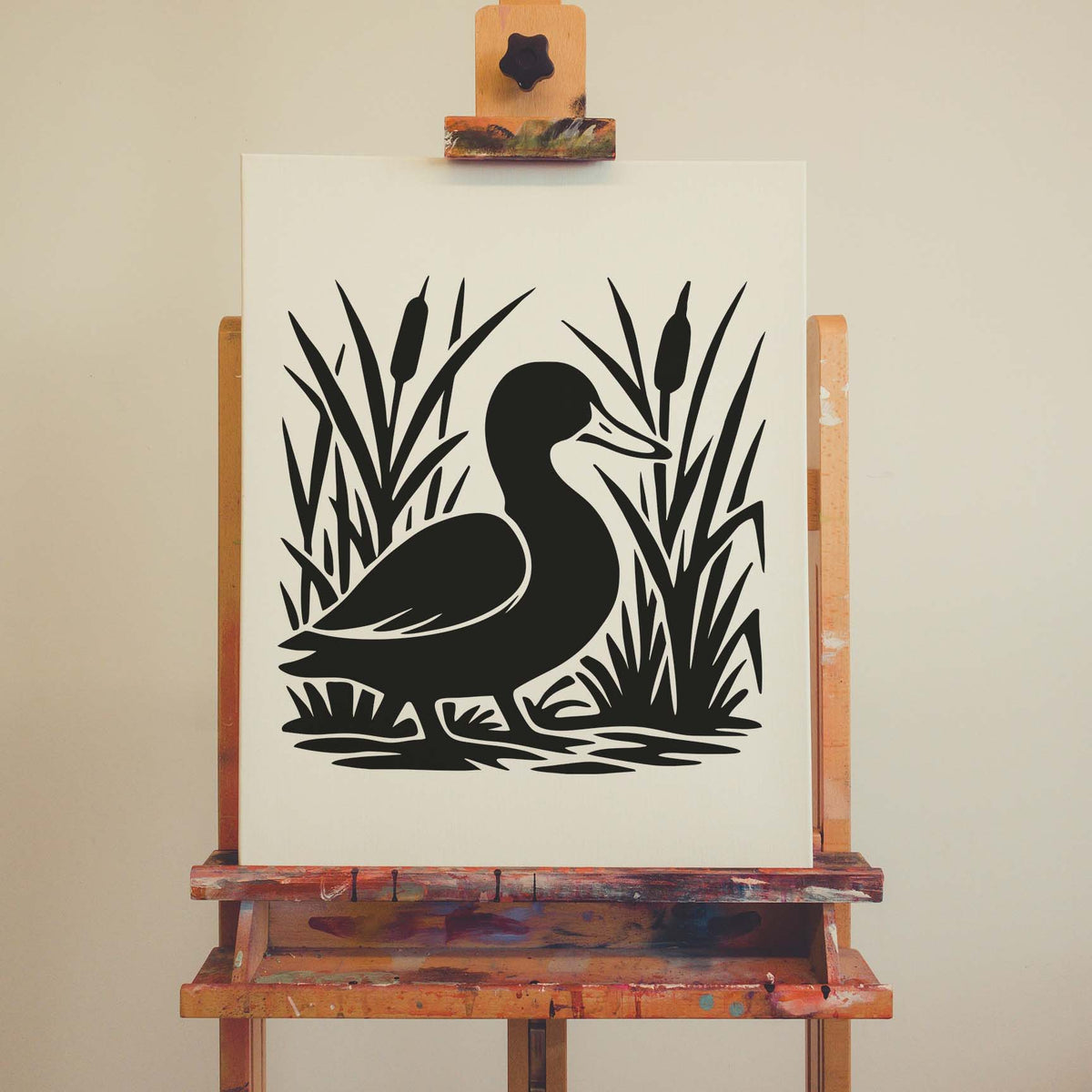 The Duck in Cattail Reeds Stencil is shown in black on a canvas resting on a wooden easel.