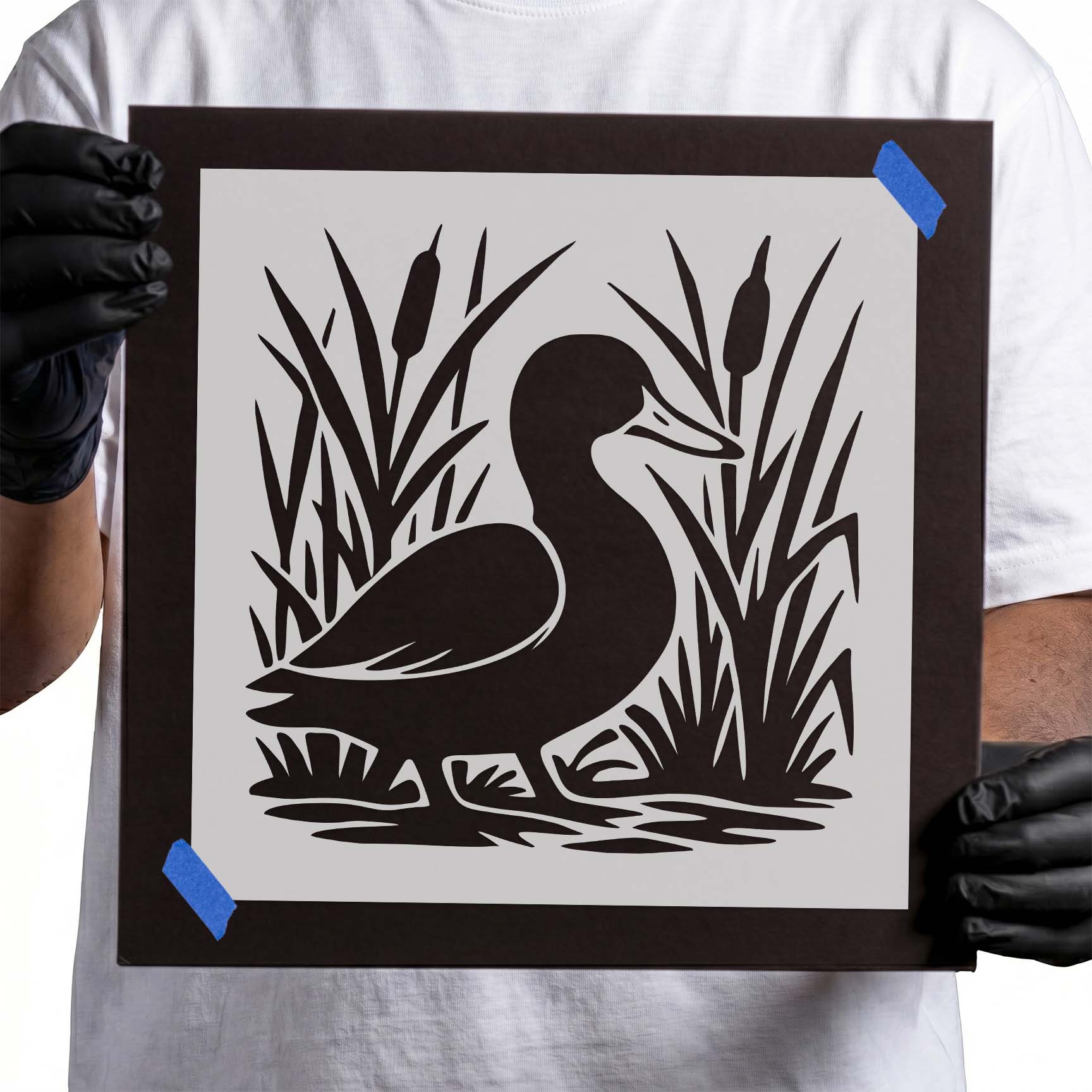 Duck stencil surrounded by tall cattail reeds and marsh grasses