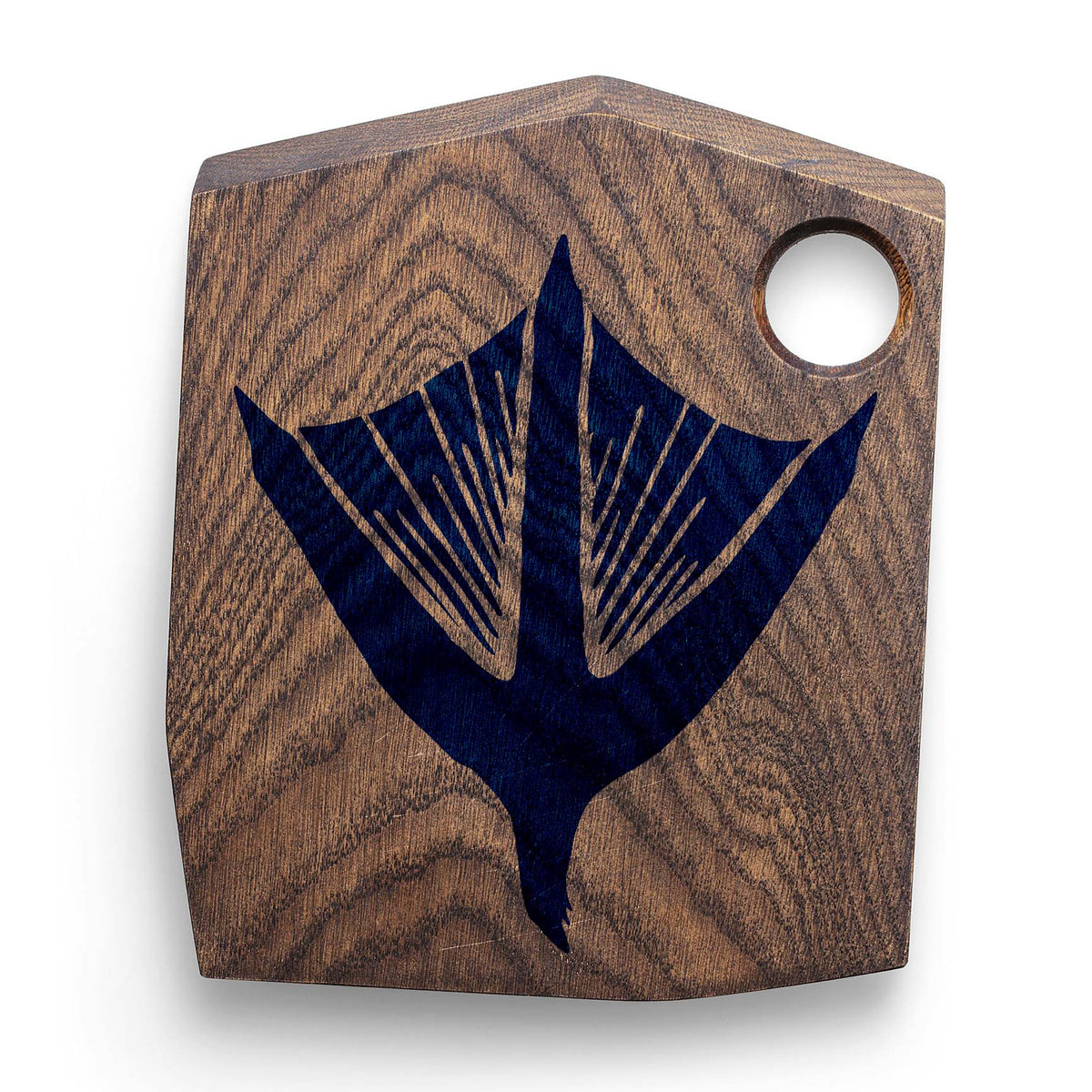Deep blue Duck Track Stencil artwork marks a rustic wooden cutting board with a distinctive webbed foot design.