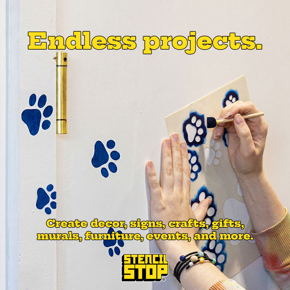 paw stencils being painted on a wall