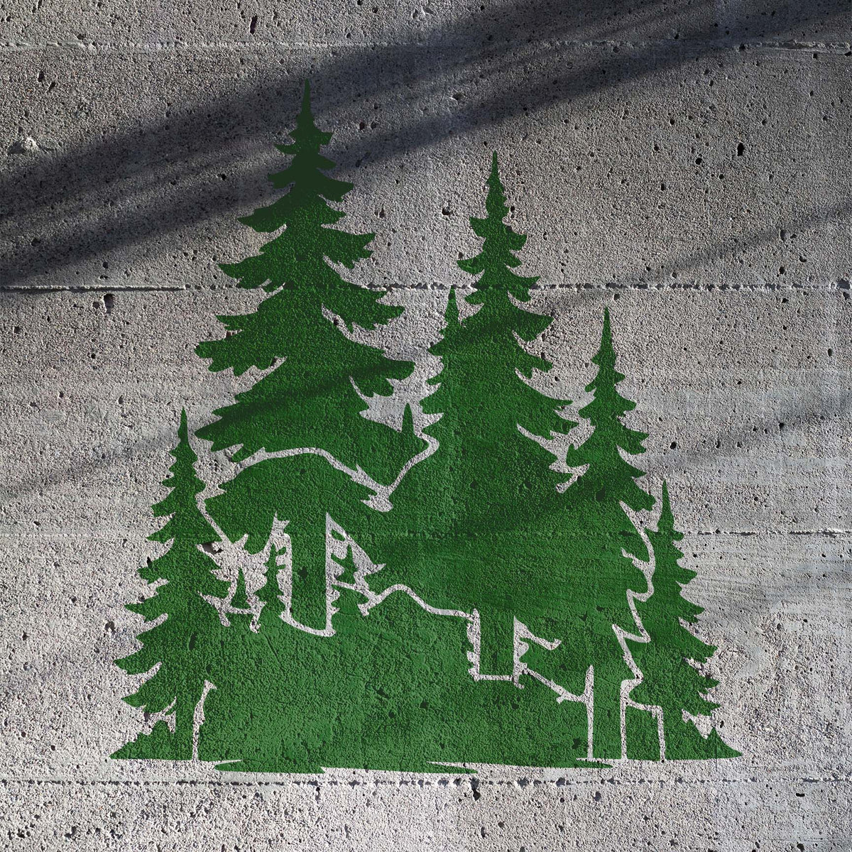 A forest of green evergreens covers textured concrete in the Evergreen Woodland Trees Stencil design.