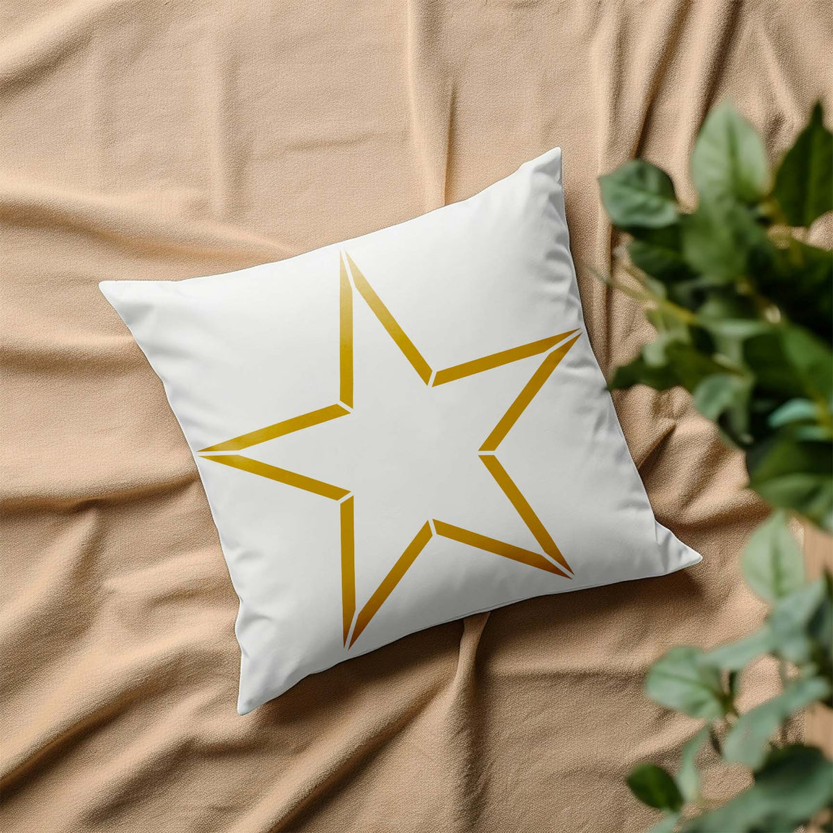 A gold Five Point Star Outline Stencil decorates a white pillow with a clean geometric star design