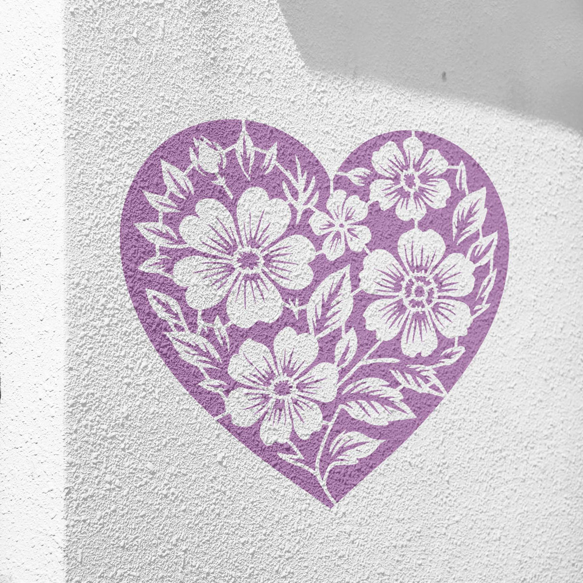 Soft purple Floral Heart Silhouette Stencil decorates a textured white wall with flowers and leaves