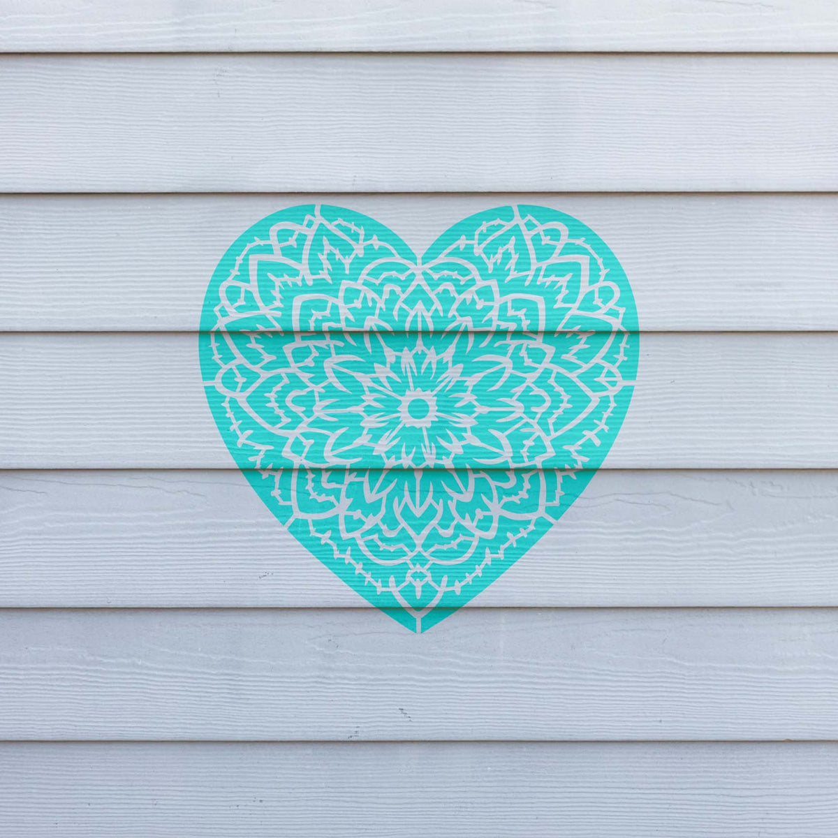 Turquoise Floral Mandala Heart Stencil stands out with detailed petals on white wood siding
