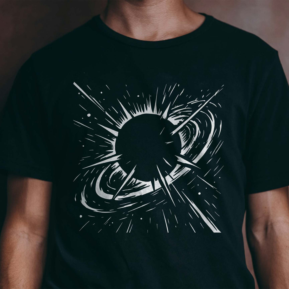 Galactic Solar Burst Stencil radiates across a black T-shirt with swirling celestial details
