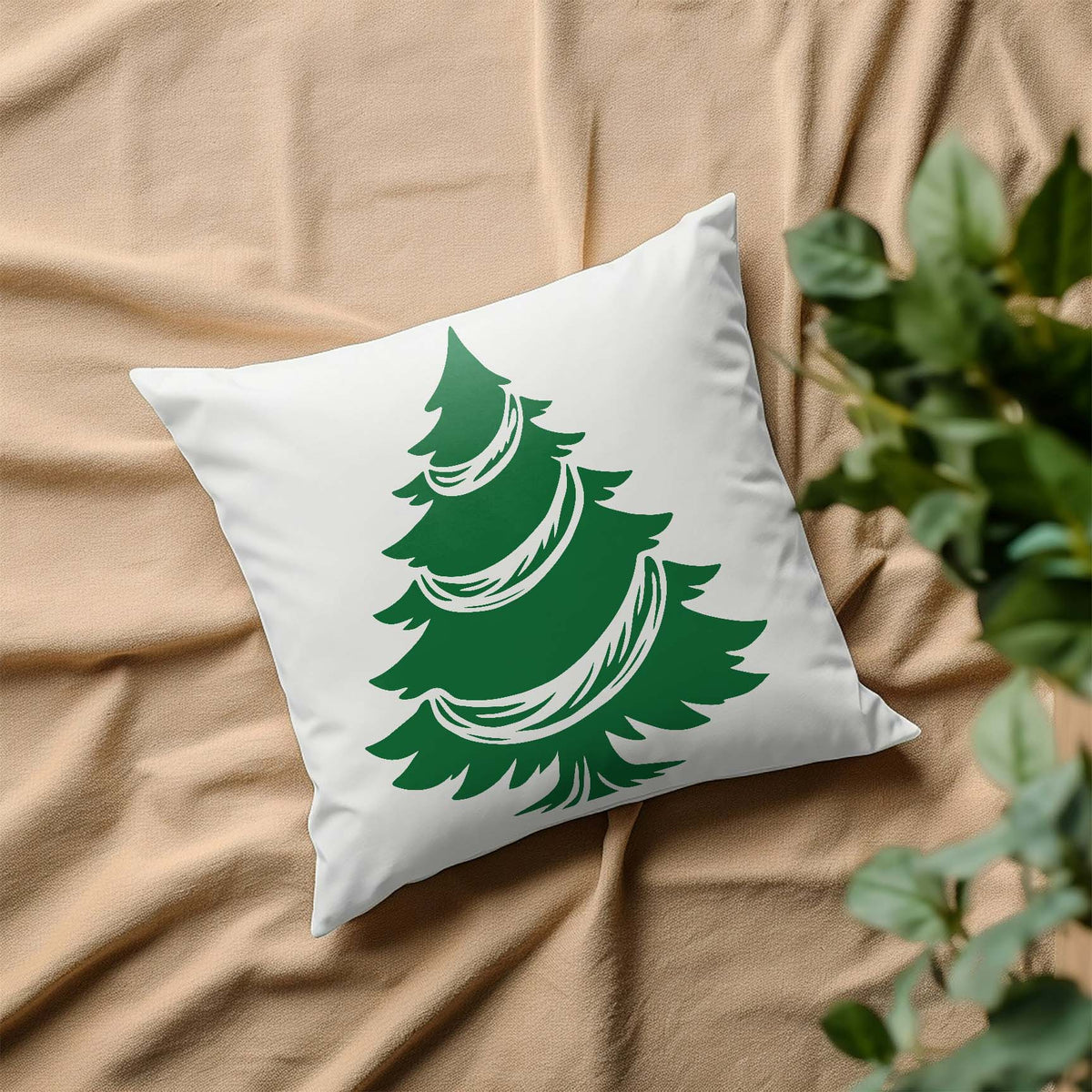 White throw pillow featuring the Garland Christmas Tree Stencil in green