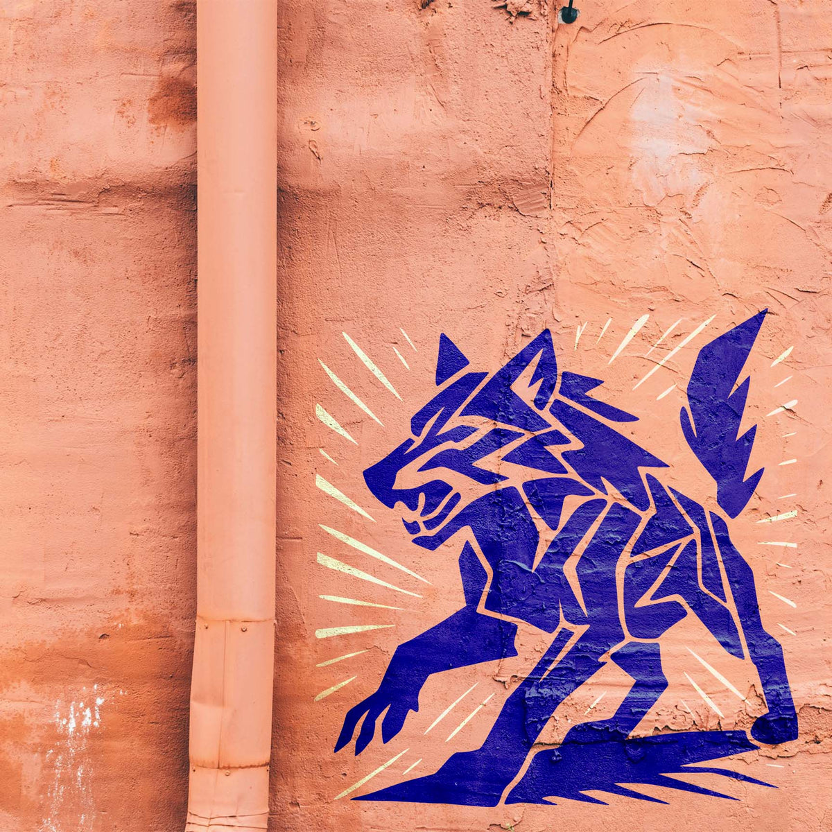 Geometric Wolf Stencil painted in blue on a textured salmon wall