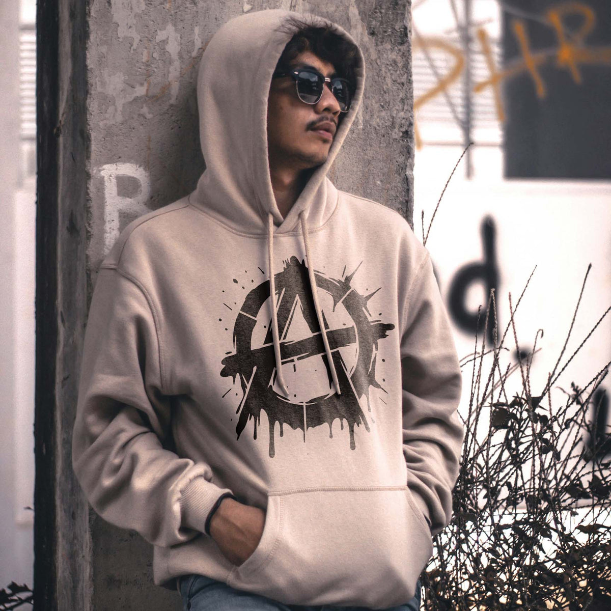 A bold Graffiti Anarchy Symbol Stencil adds a black circle-A design with splattered edges to a beige hoodie.