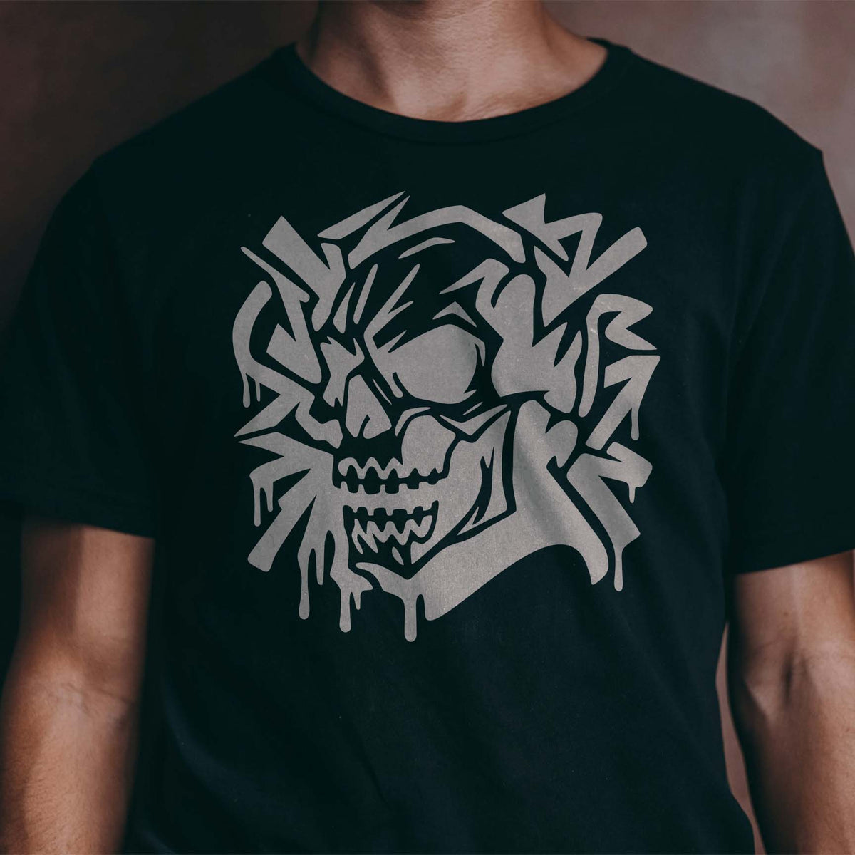 Graffiti Skull Stencil stands out in gray with dripping street-art details on a black shirt