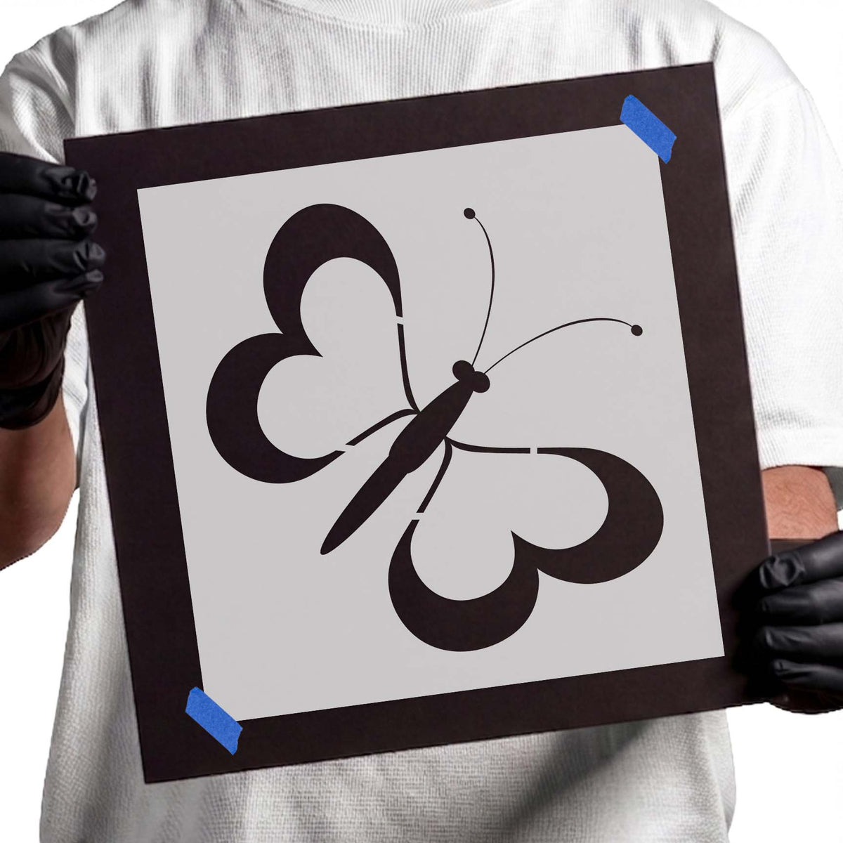 Butterfly stencil with four heart-shaped wings and curved antennae