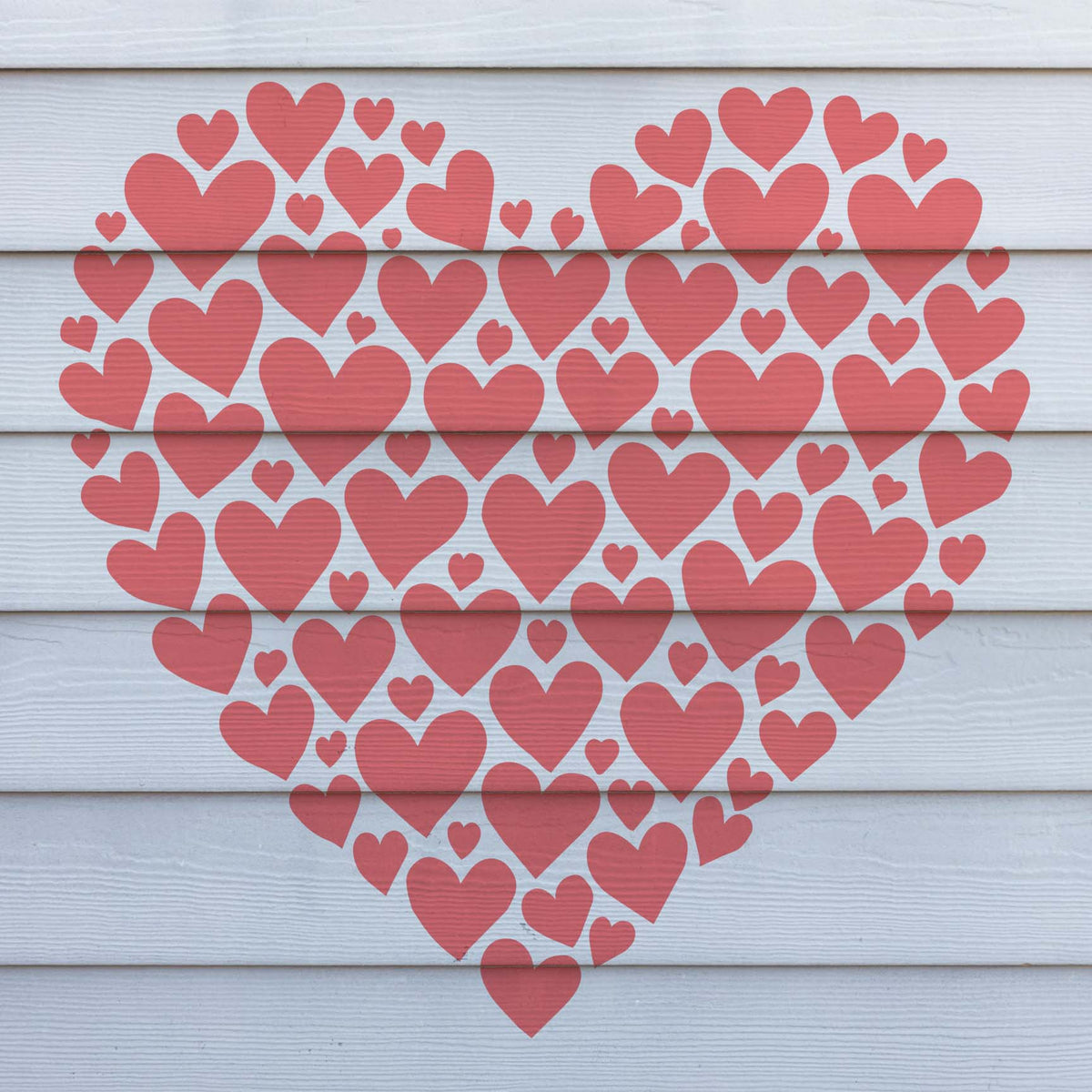 A playful cluster of red hearts from the Heart Mosaic Stencil fills a heart shape across white siding