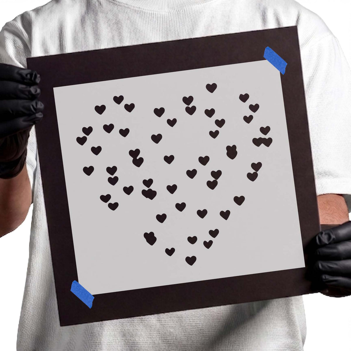 Small heart shapes arranged into a large heart stencil design