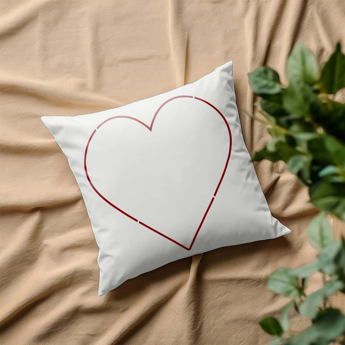 A white pillow features the Heart Outline Stencil in a delicate red heart design for a clean look