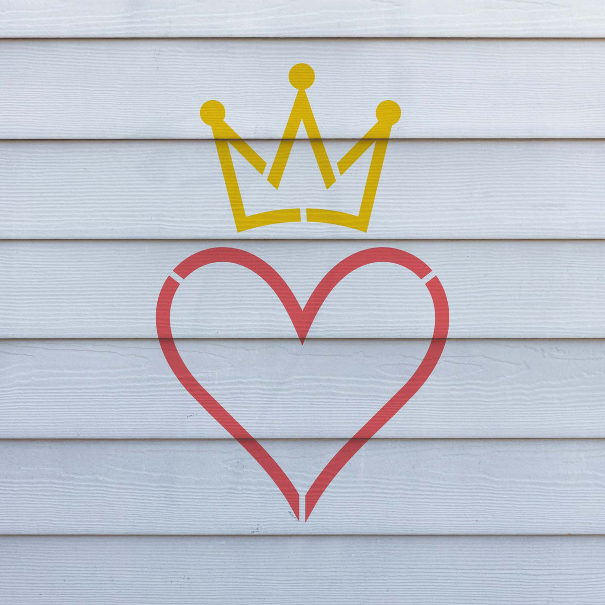 A bright Crowned Heart Outline Stencil displays a red heart and yellow crown across white siding