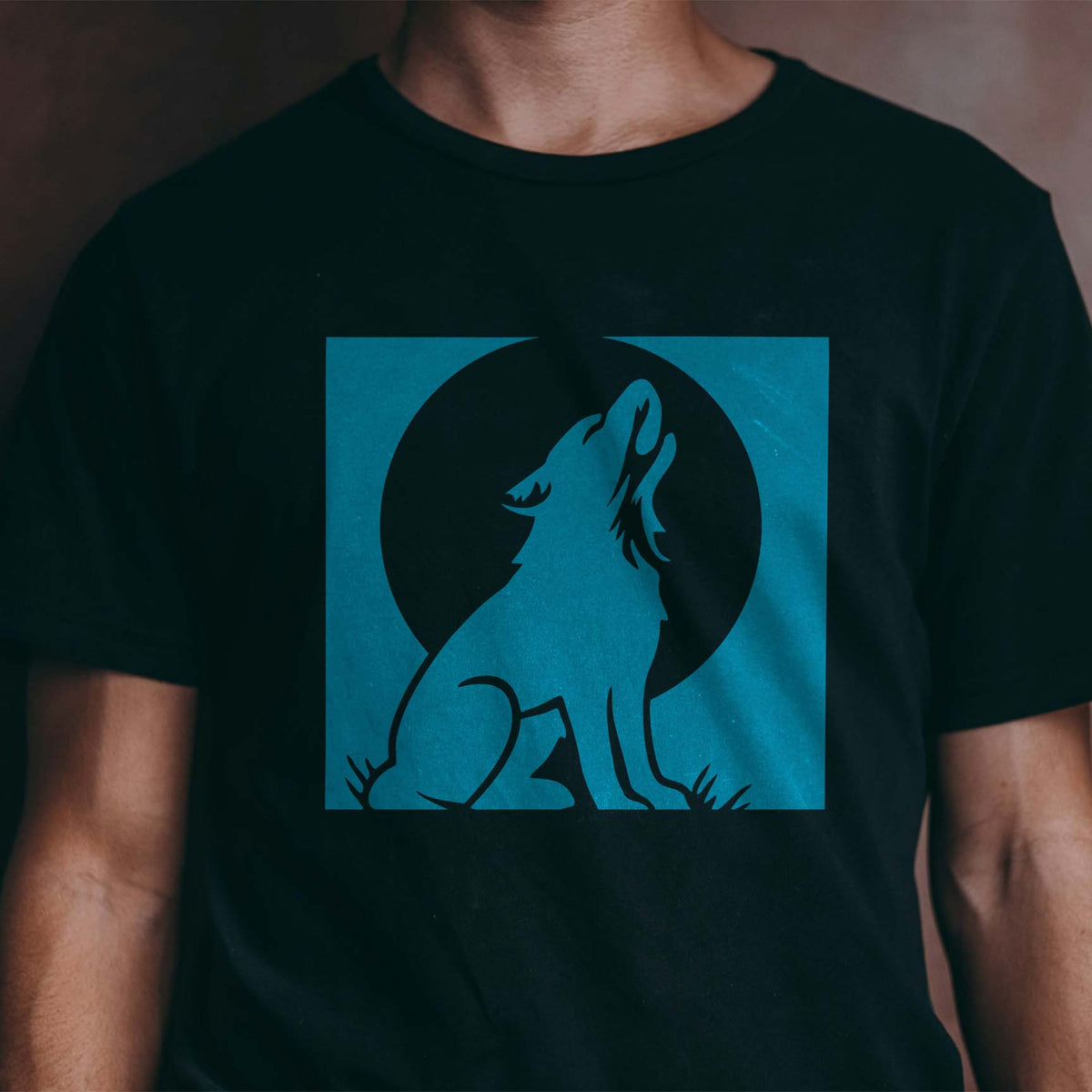 Black T-shirt featuring the Howling Dog Moon Stencil in blue with a moonlit howling dog design.
