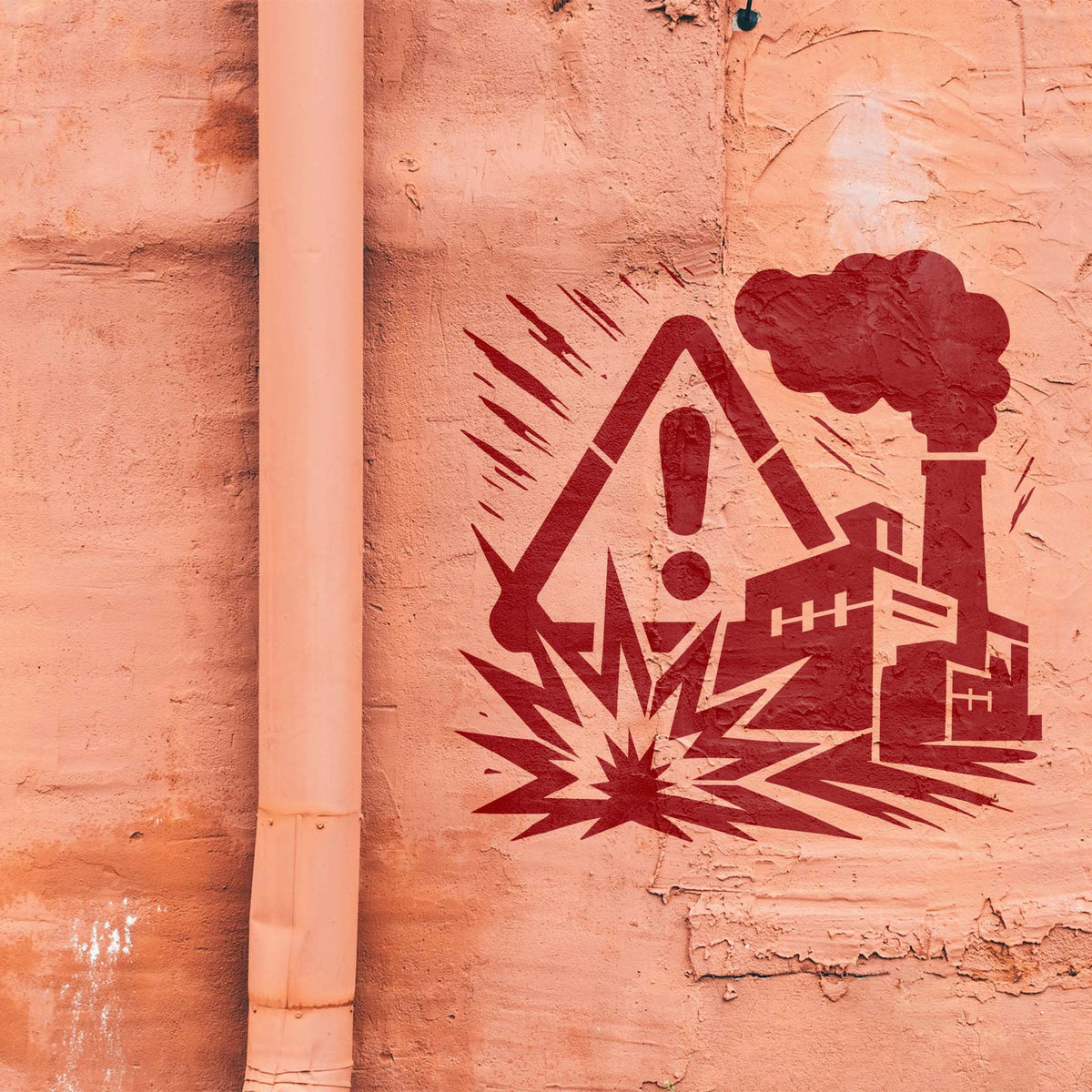 Painted on a weathered wall, Industrial Hazard Factory Warning Stencil shows a smoking factory and alert sign.