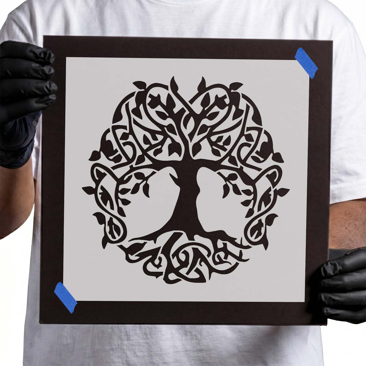 Intricate tree stencil with interwoven branches, curling vines, delicate leaves, and circular knotwork