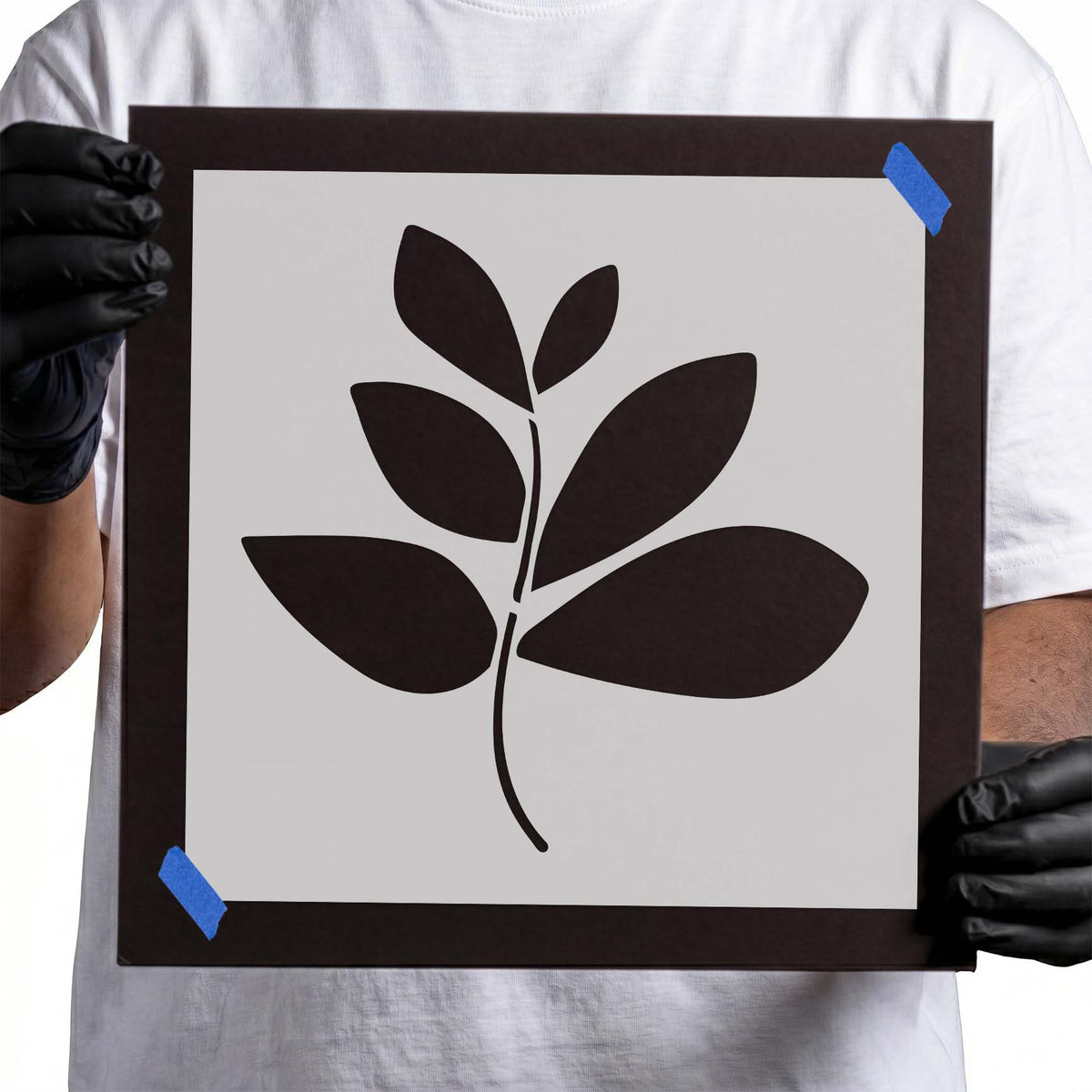 Botanical stencil showing six broad pointed leaves along a slender curved branch