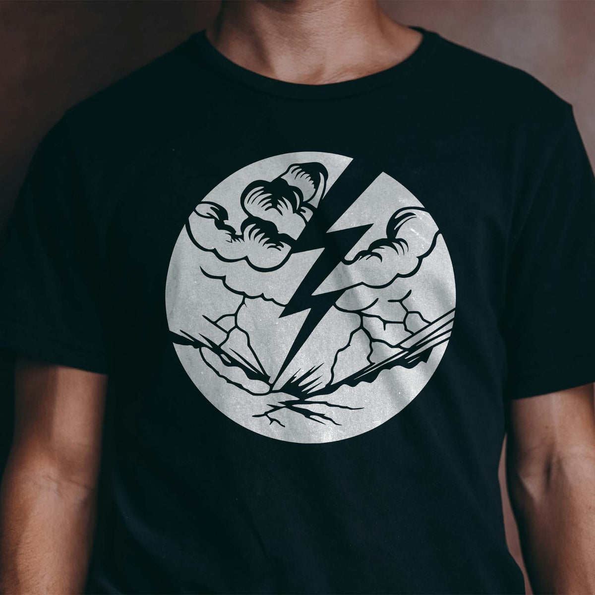 Silver Lightning Strike Storm Stencil cuts through billowing clouds on a black T-shirt
