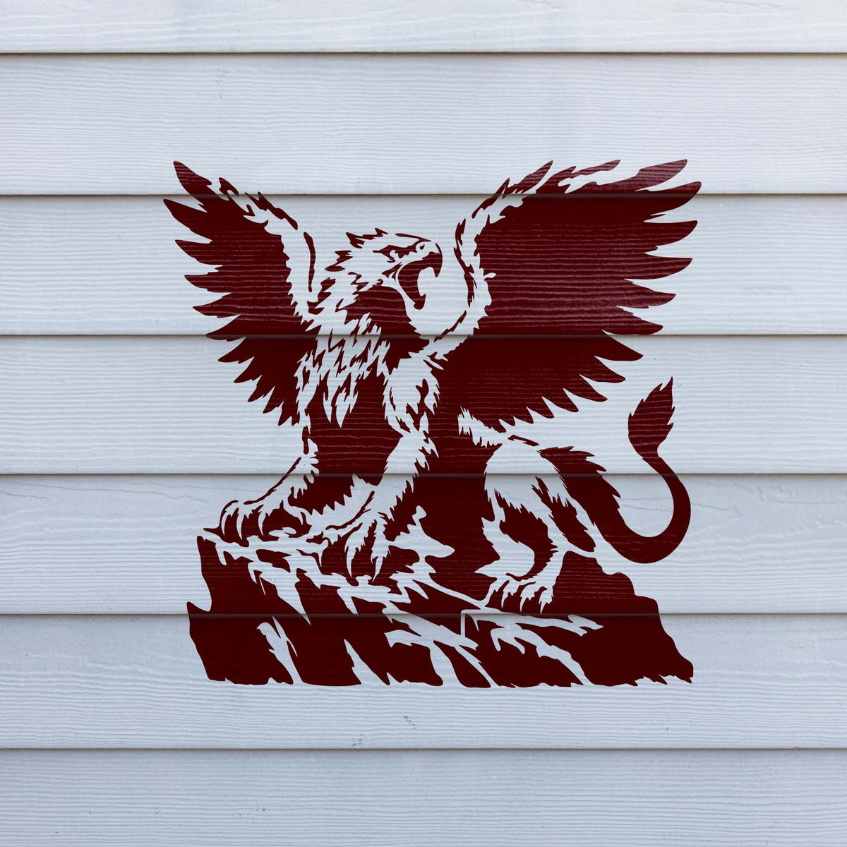 Bold Majestic Griffin on Cliff Stencil shows a roaring winged griffin painted across white exterior siding.