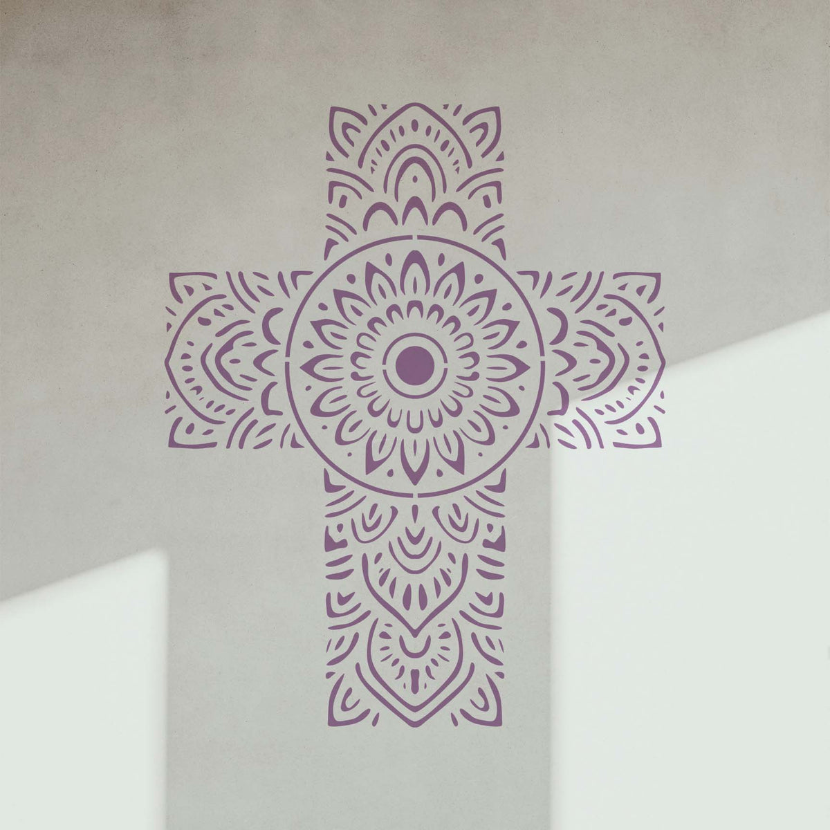 Ornate purple Mandala Floral Cross Stencil displayed on a softly shadowed interior wall