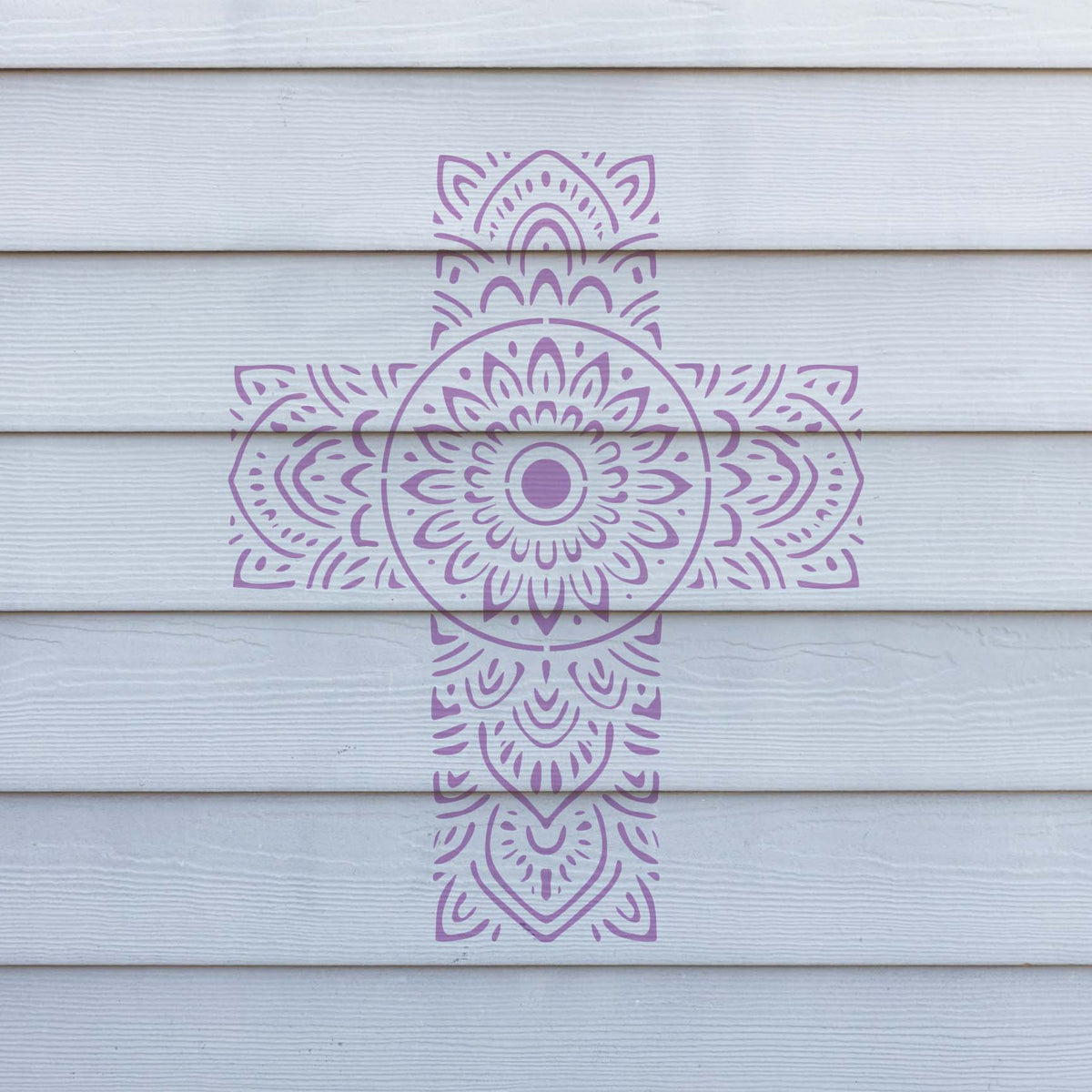 Delicate Mandala Floral Cross Stencil painted purple across white horizontal wall siding