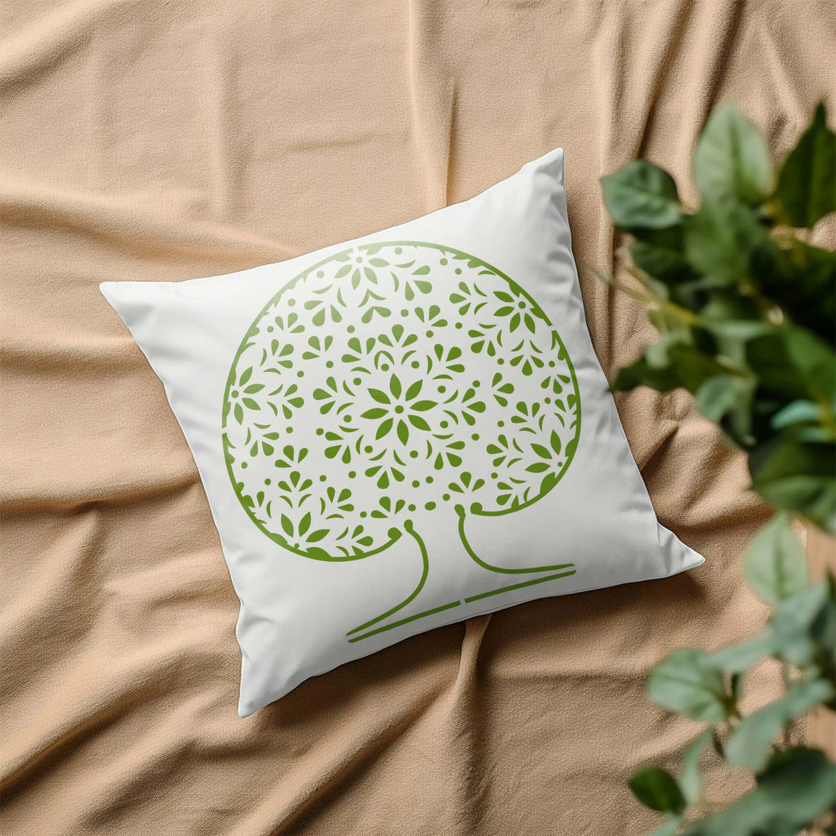 Mandala Tree of Life stencil in green displayed on a white pillow