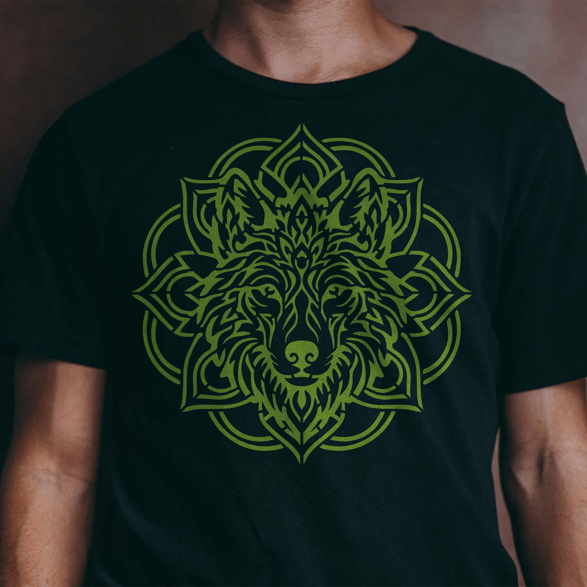 Mandala Wolf Head Stencil stands out in green with intricate wolf details on a black shirt.