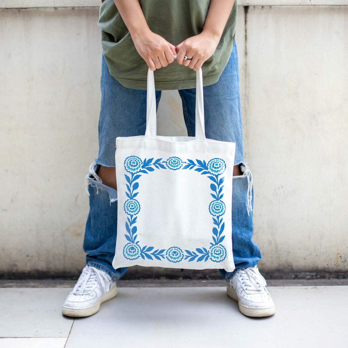 Floral Marigold Border stencil framing a white tote bag in blue