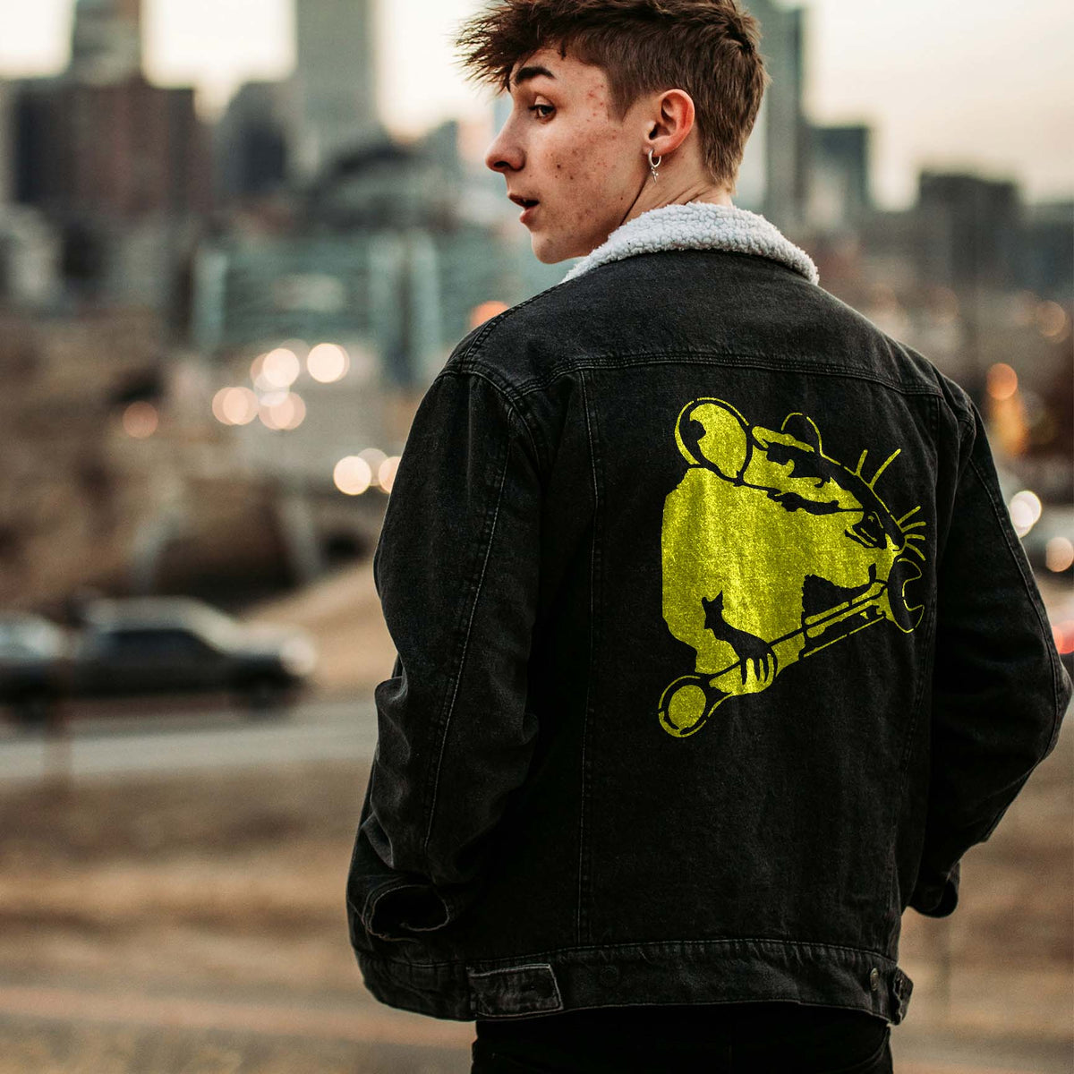 Mechanic Rat with Wrench Stencil in bright yellow across a black denim jacket