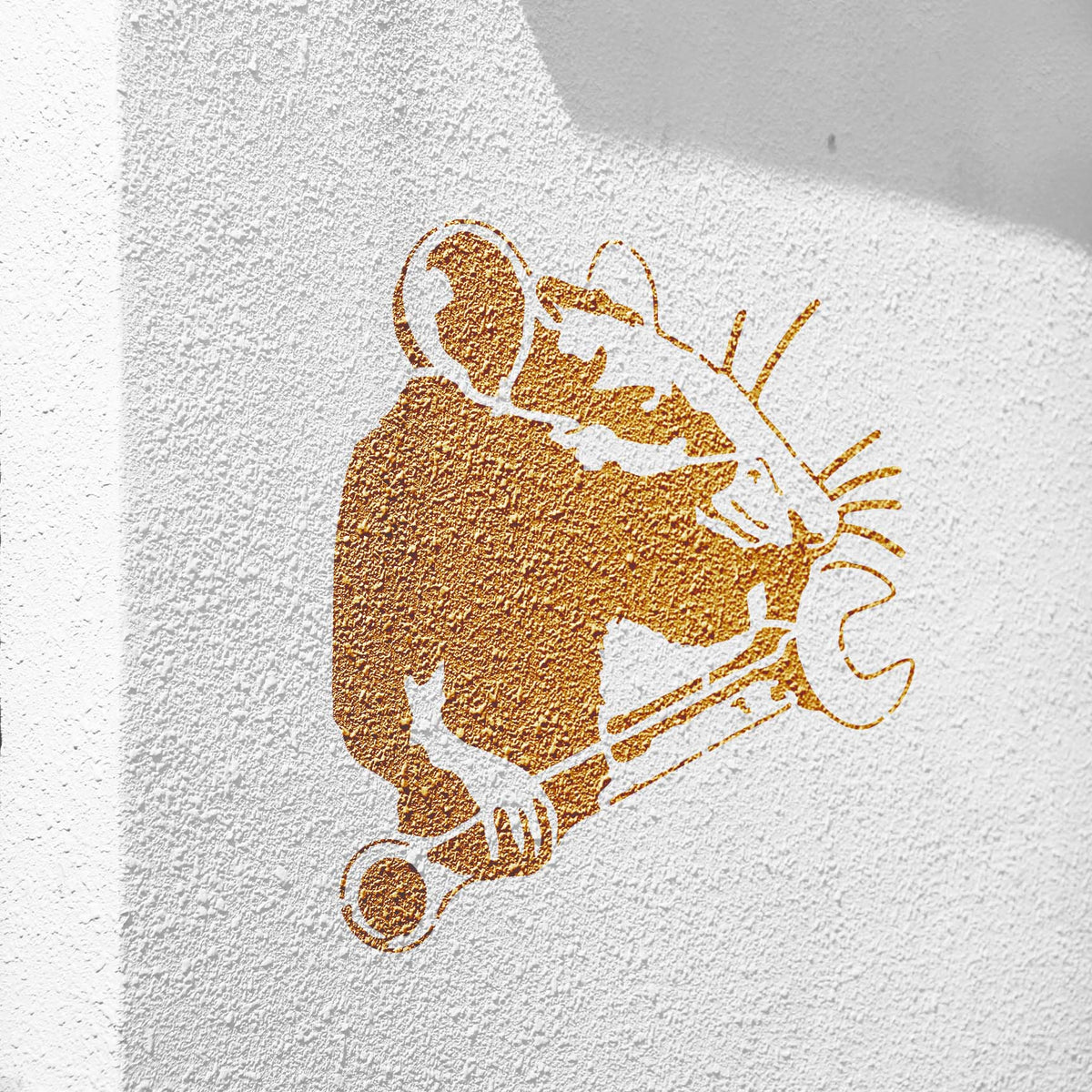 Golden Mechanic Rat with Wrench Stencil painted over a sunlit textured white wall