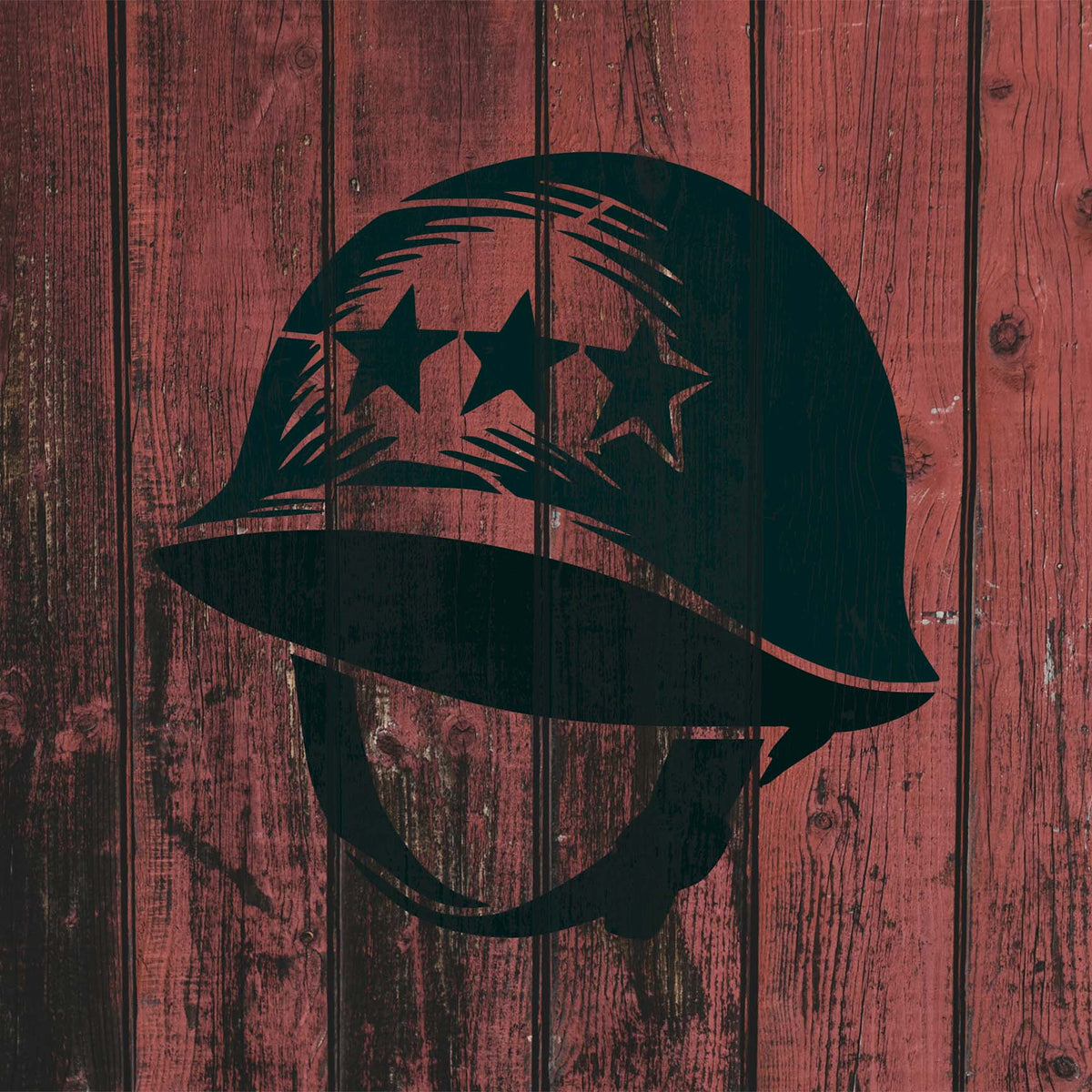 Military Combat Helmet Stencil with three stars painted on a rustic red wood surface.