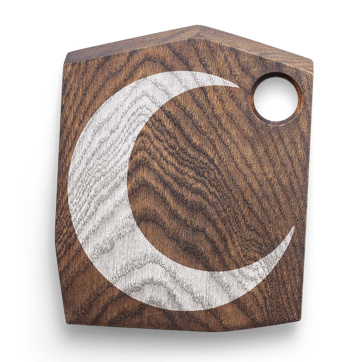 Rustic wood grain meets the Minimalist Crescent Moon Stencil in white on a dark wooden cutting board.