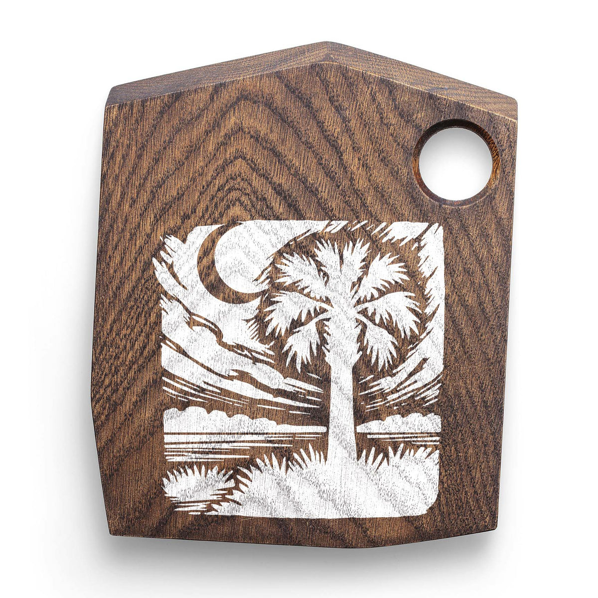 Rustic wood board showcases the Moonlit Palmetto Landscape Stencil with moonlit palm scenery