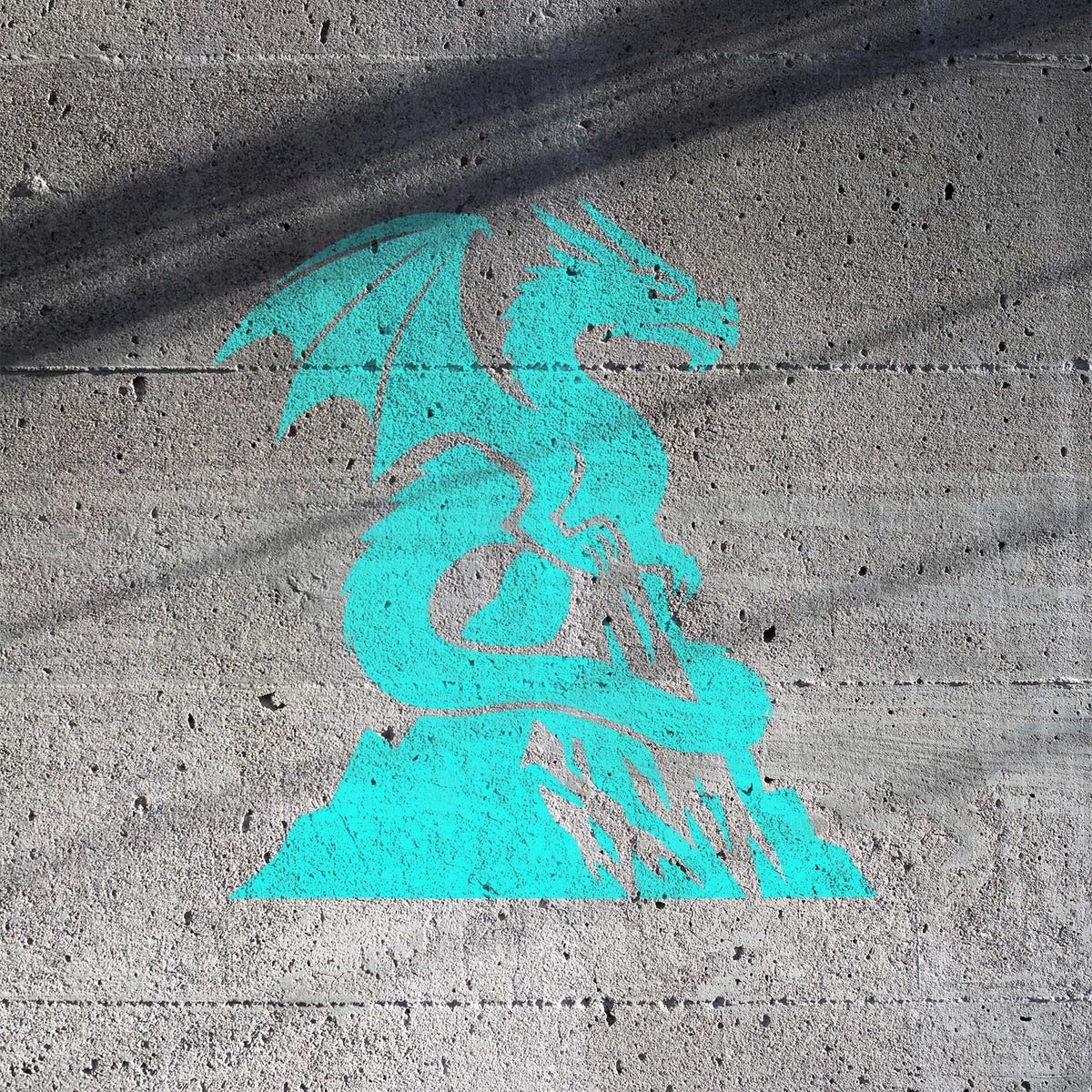 Turquoise Mountain Peak Dragon Stencil painted boldly across a rough concrete wall